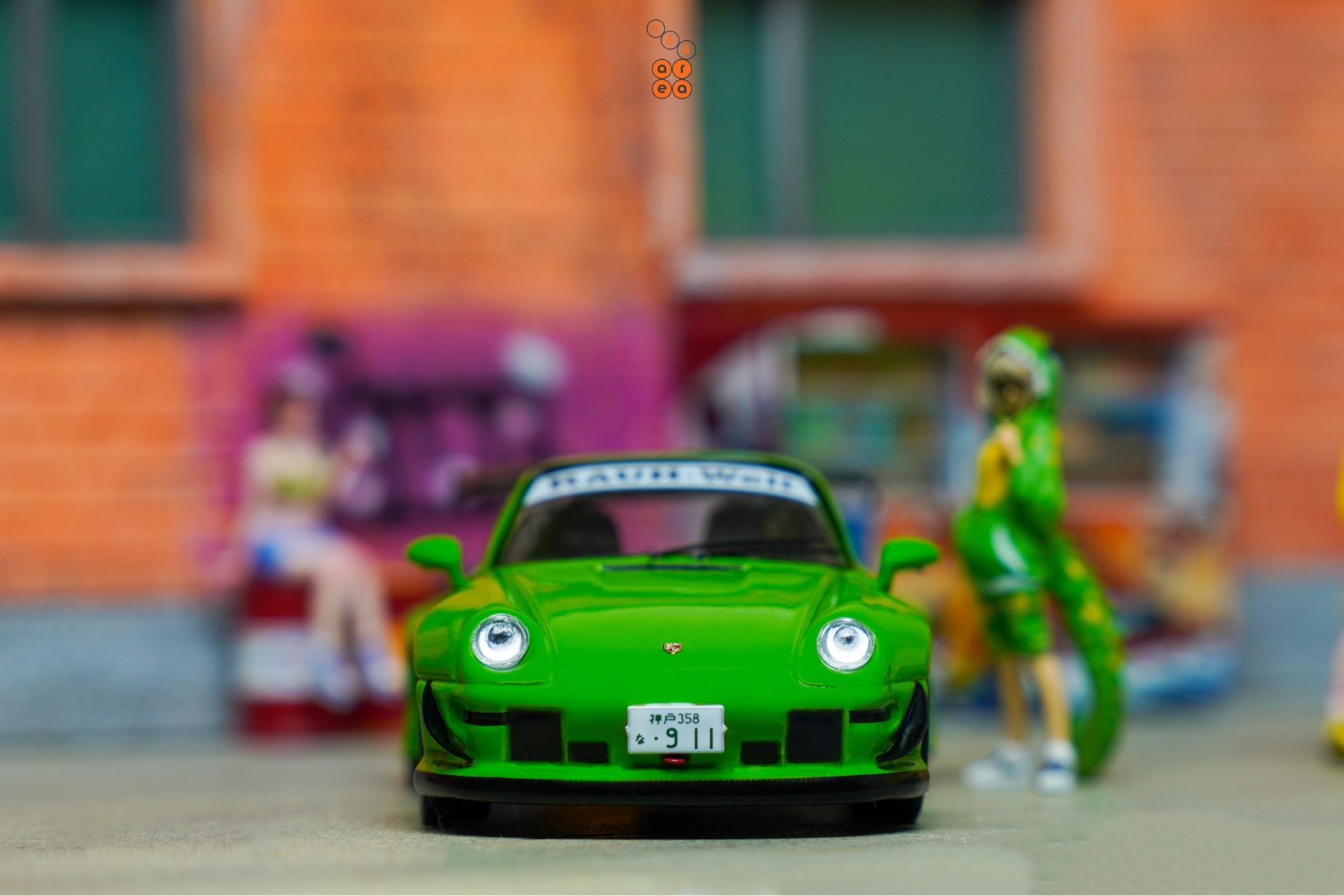 A front side of Porsche RWB 993 Rough Rhythm by Tarmac Works in 1:64 scale with 1:64 figures on AREA 164