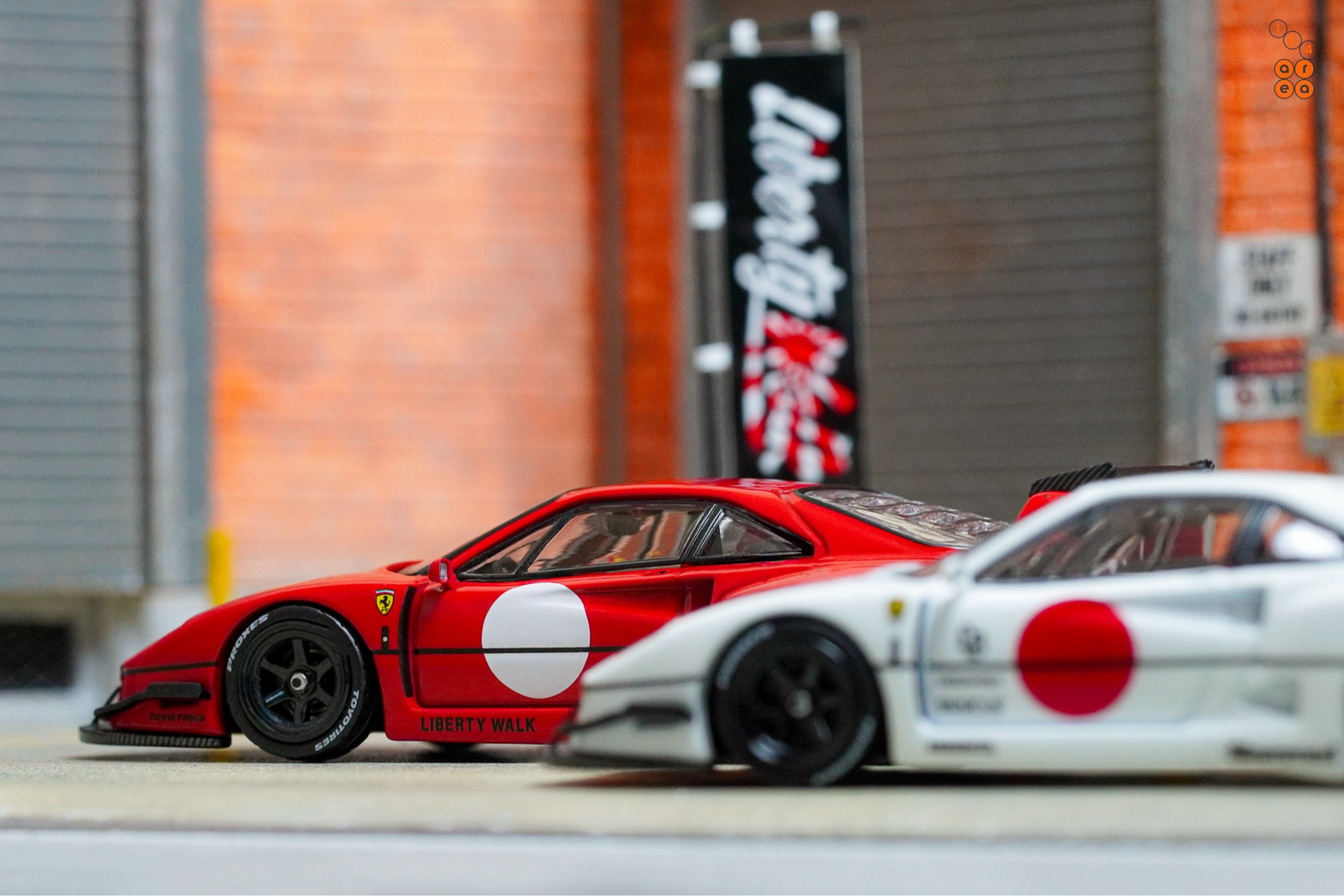 A red and a white LB-WORKS Ferrari F40 with Japan flag symbol by INNO64 in 1:64 scale on AREA 164