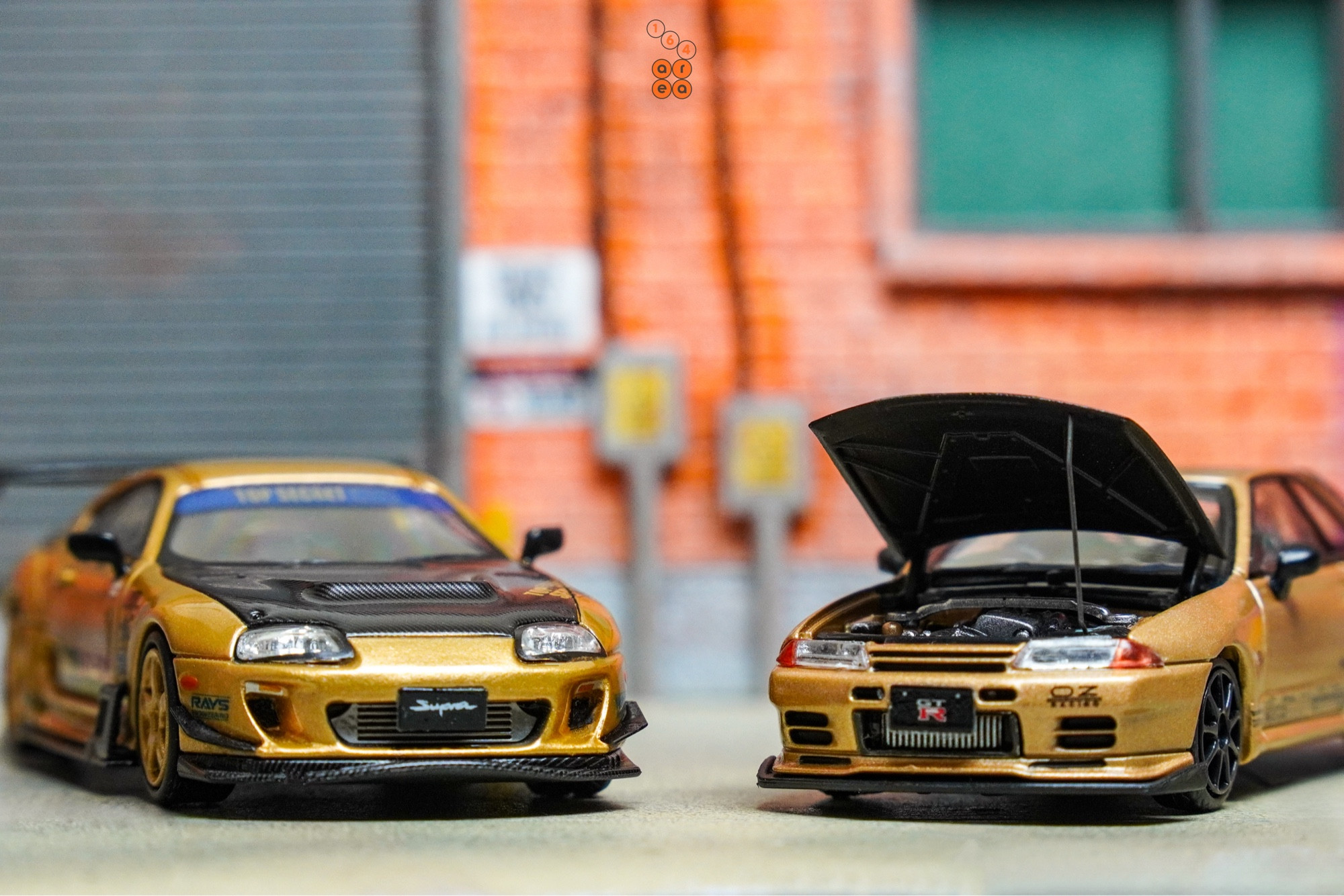 Toyota Supra A80 by Time Micro and Nissan Skyline GT-R VR32 by Facal Horizon both with Top Secret Gold livery in 1:64 scale on AREA 164