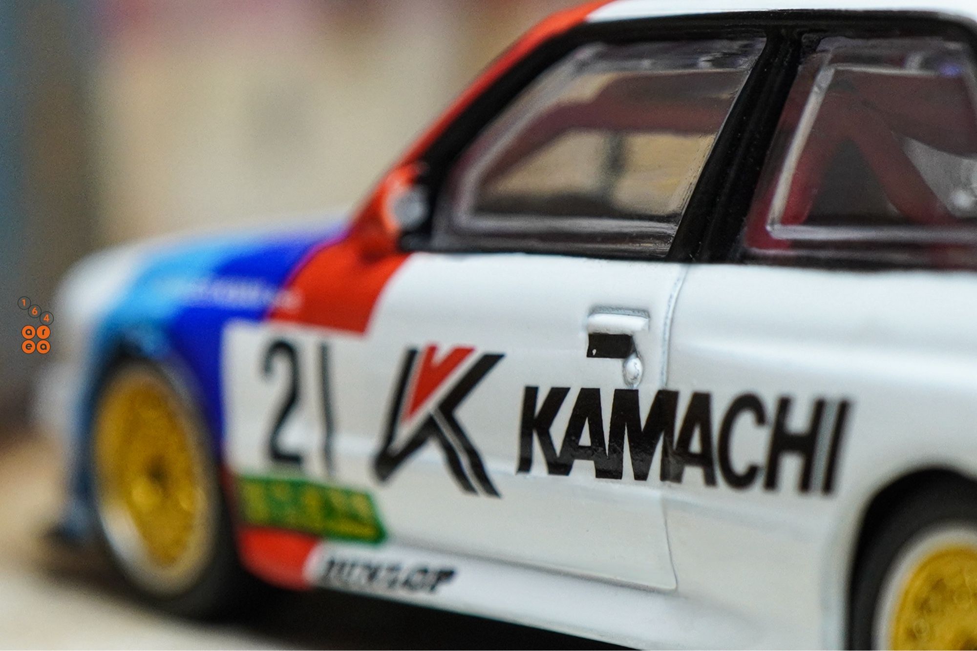 A close-up shot of BMW E30 M3, Kamachi racing livery by Tarmac Works in 1:64 scale  on AREA 164