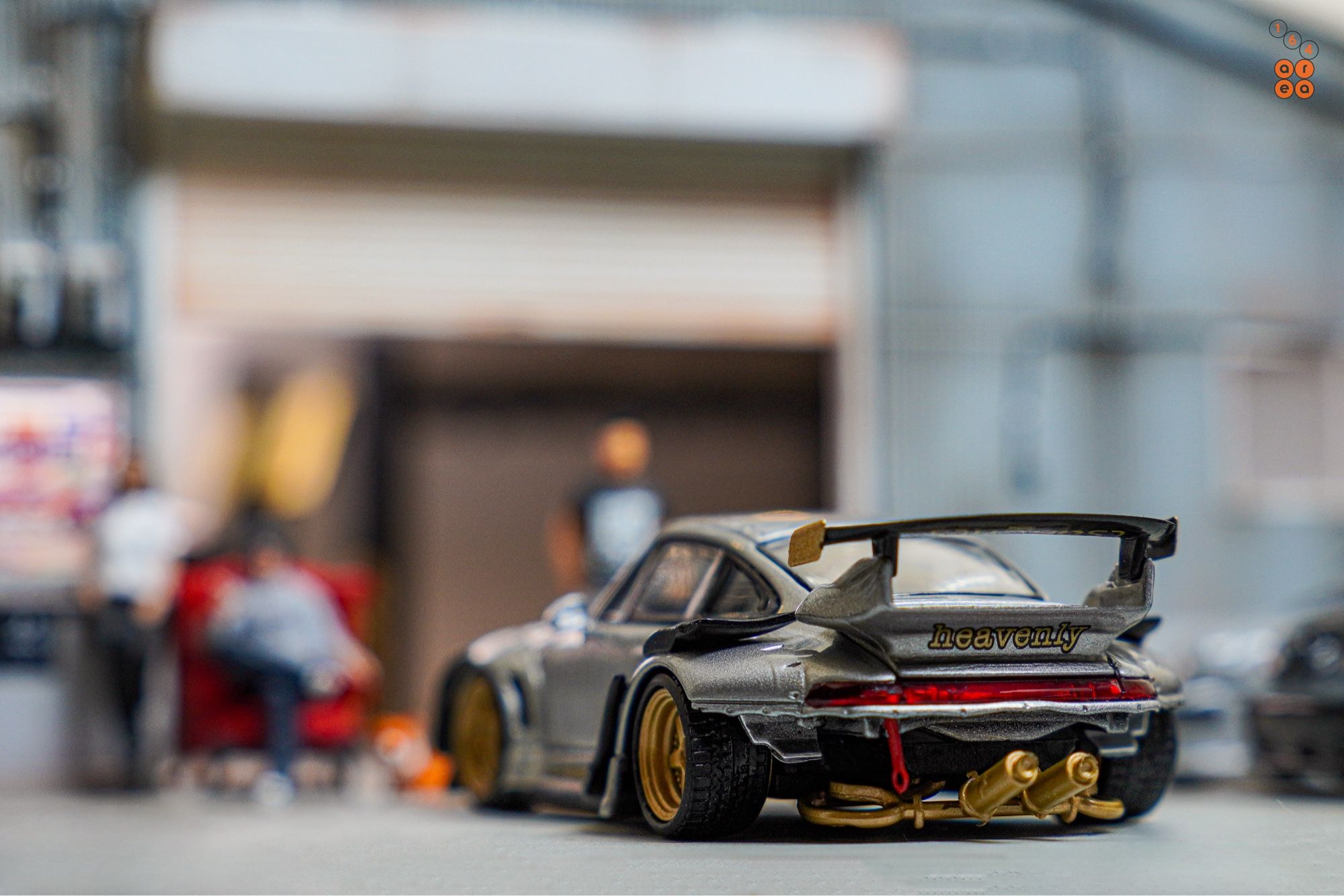 A rear side of Porsche RWB 993 Ram-intra with wording "heavenly" by Street Weapon in 1:64 scale with 1:64 figures on AREA 164