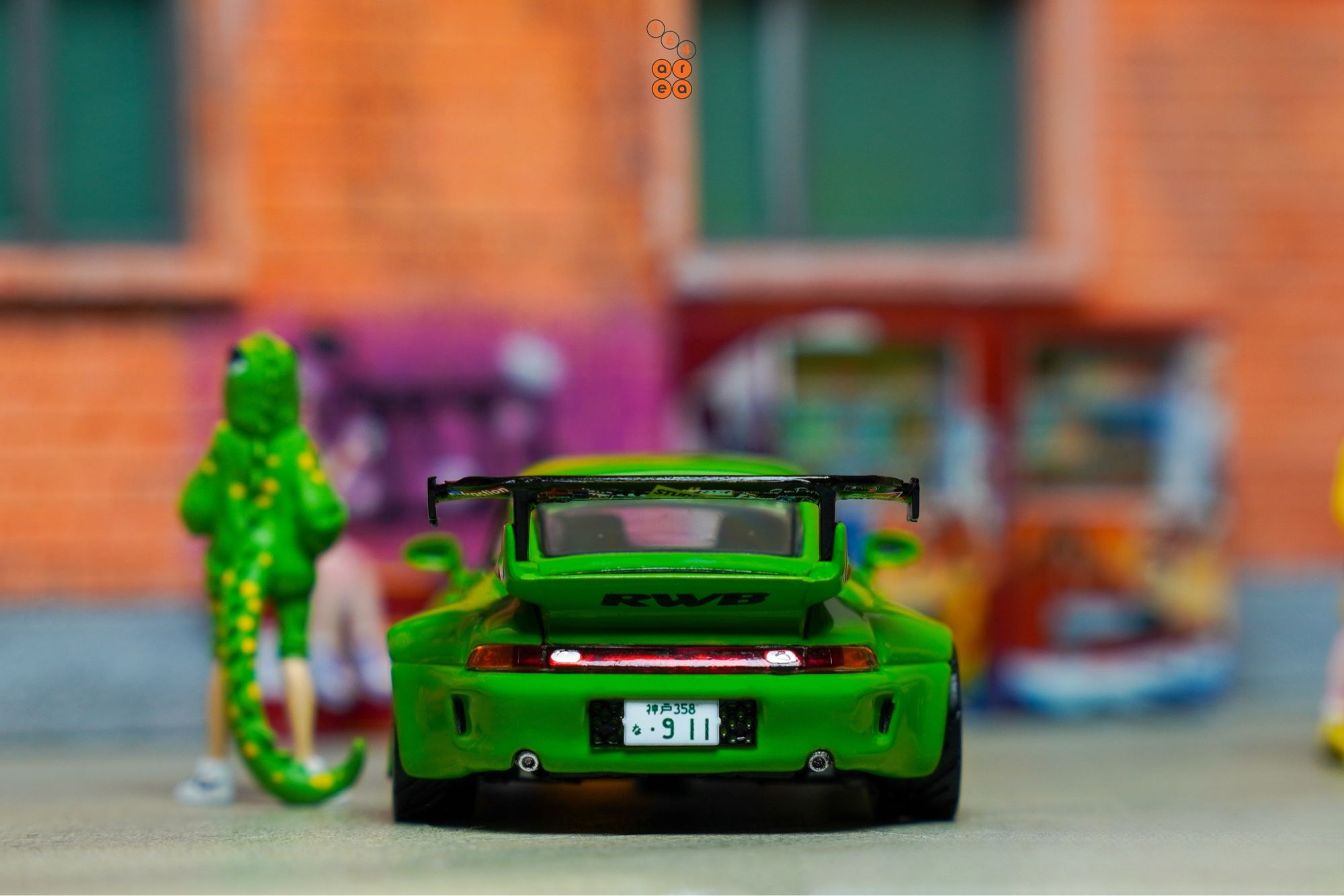 A rear side of Porsche RWB 993 Rough Rhythm by Tarmac Works in 1:64 scale with 1:64 figures on AREA 164