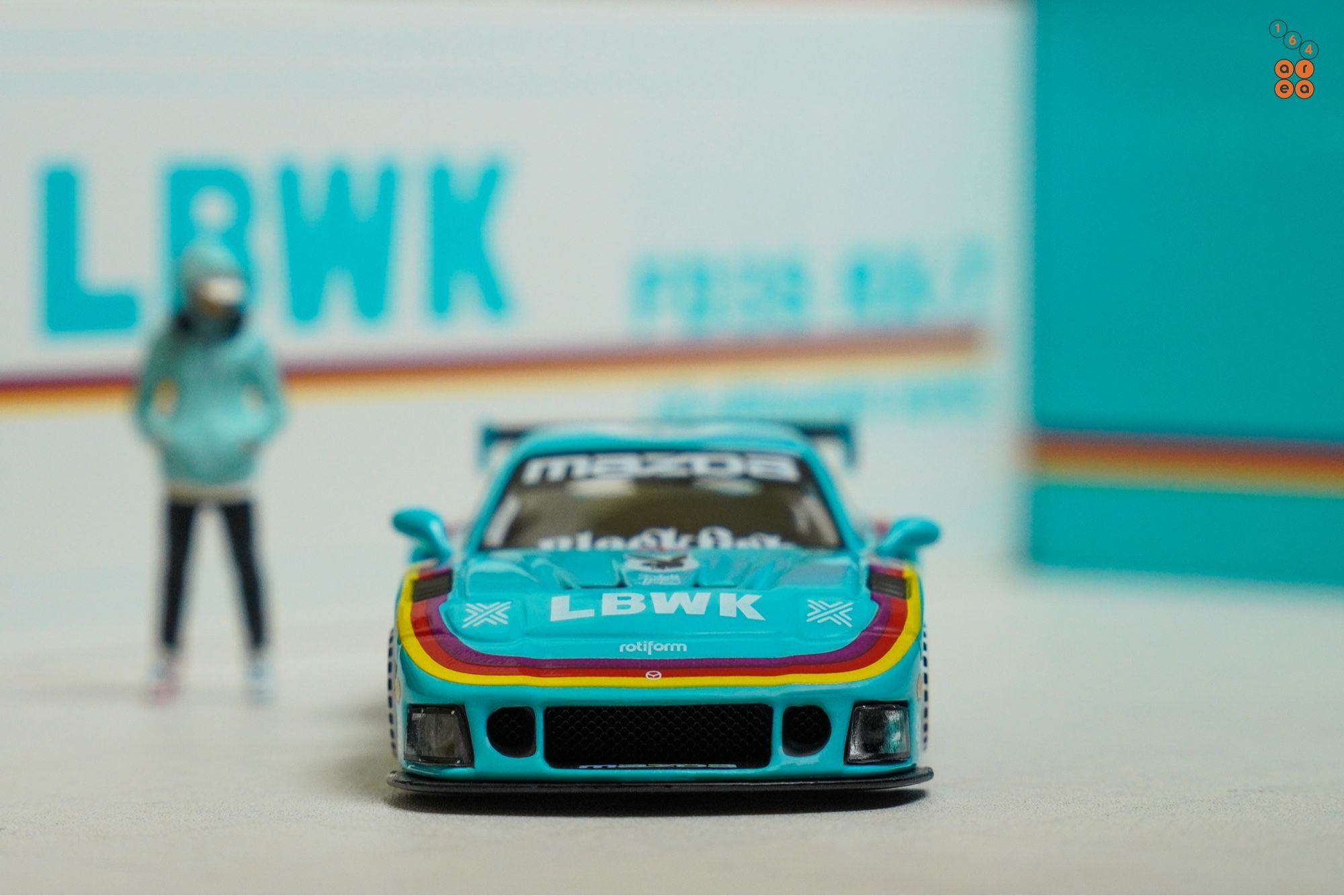 A front side of Mazda RX-7 FD3S, LB-Super Silhouette, Hobby Expo China 2024 Edition by iNNO64 in 1:64 scale with 1:64 figure on AREA 164