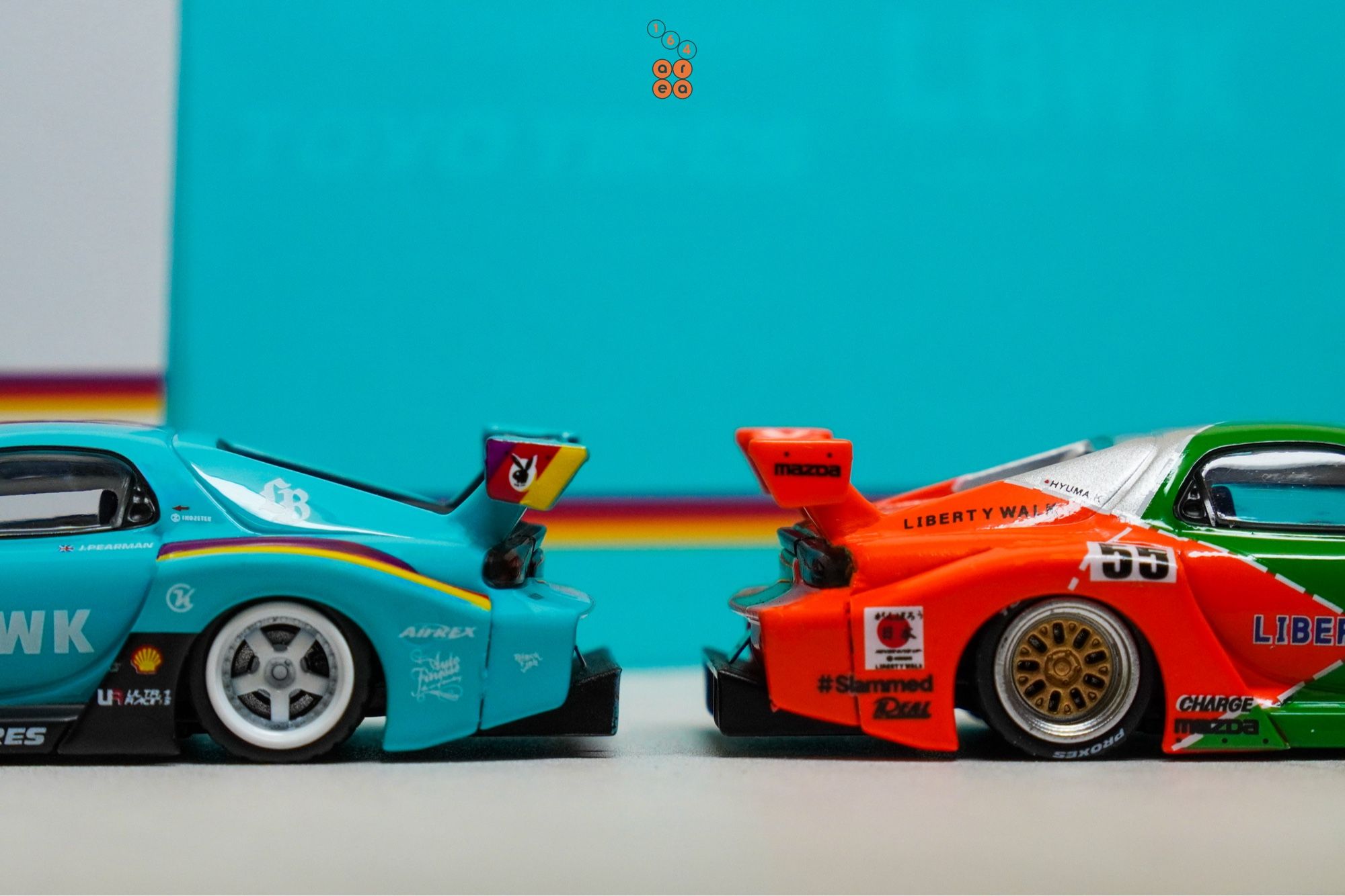 Mazda RX-7 FD3S, LB-Super Silhouette, Hobby Expo China 2024 Edition and a Renown livery one by iNNO64, both back to back in 1:64 scale with 1:64 figure on AREA 164