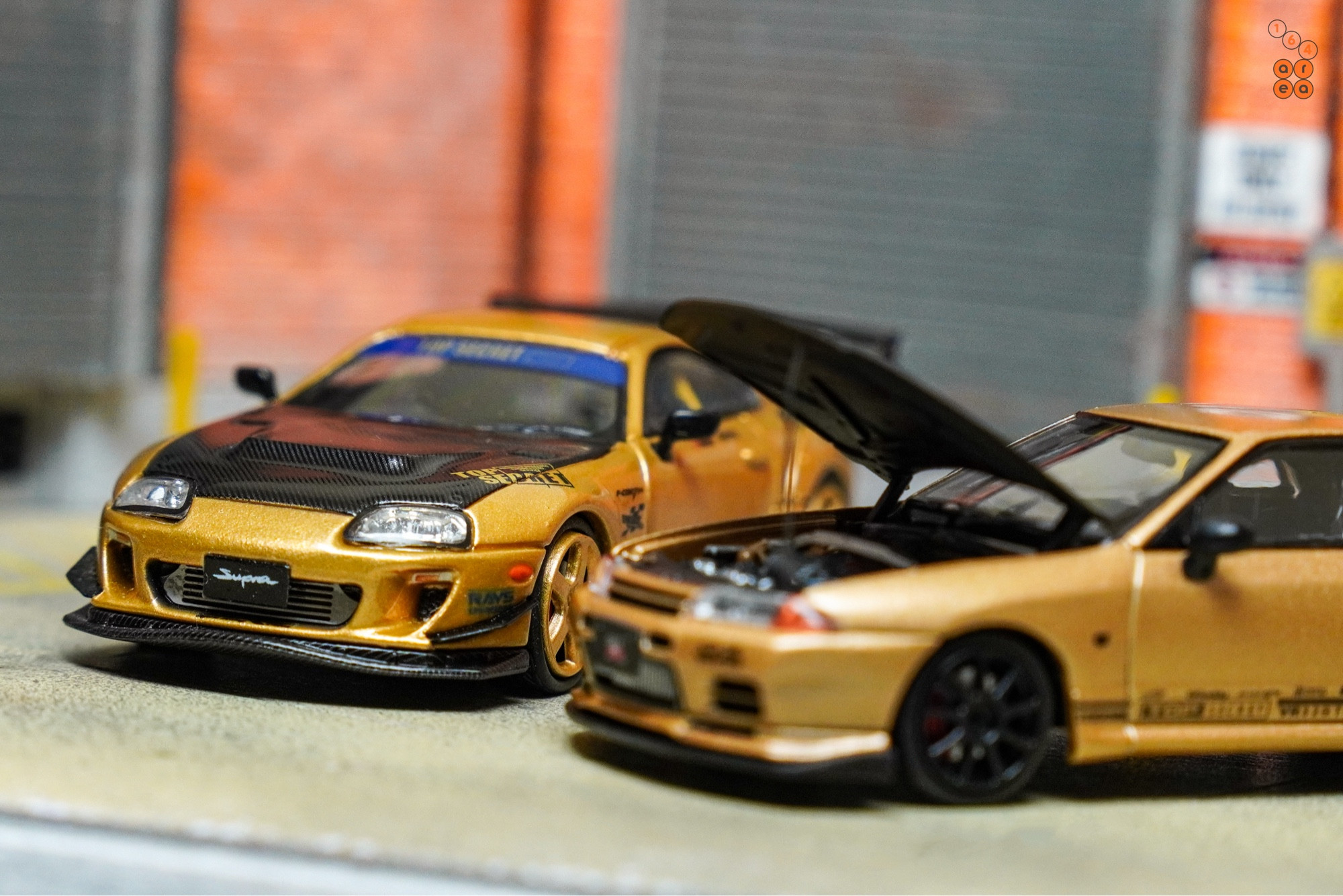 Toyota Supra A80 by Time Micro and Nissan Skyline GT-R VR32 by Facal Horizon both with Top Secret Gold livery in 1:64 scale on AREA 164