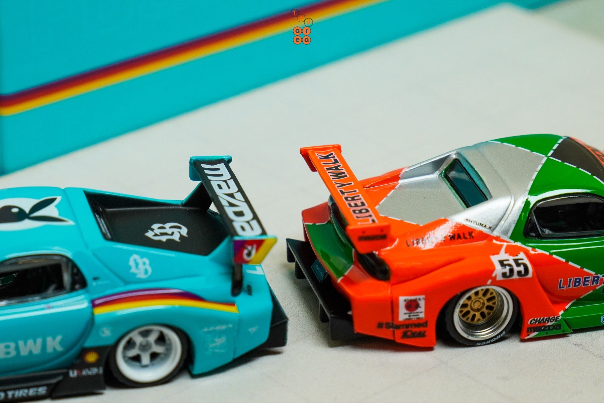 Mazda RX-7 FD3S, LB-Super Silhouette, Hobby Expo China 2024 Edition and a Renown livery one by iNNO64, both back to back in 1:64 scale with 1:64 figure on AREA 164