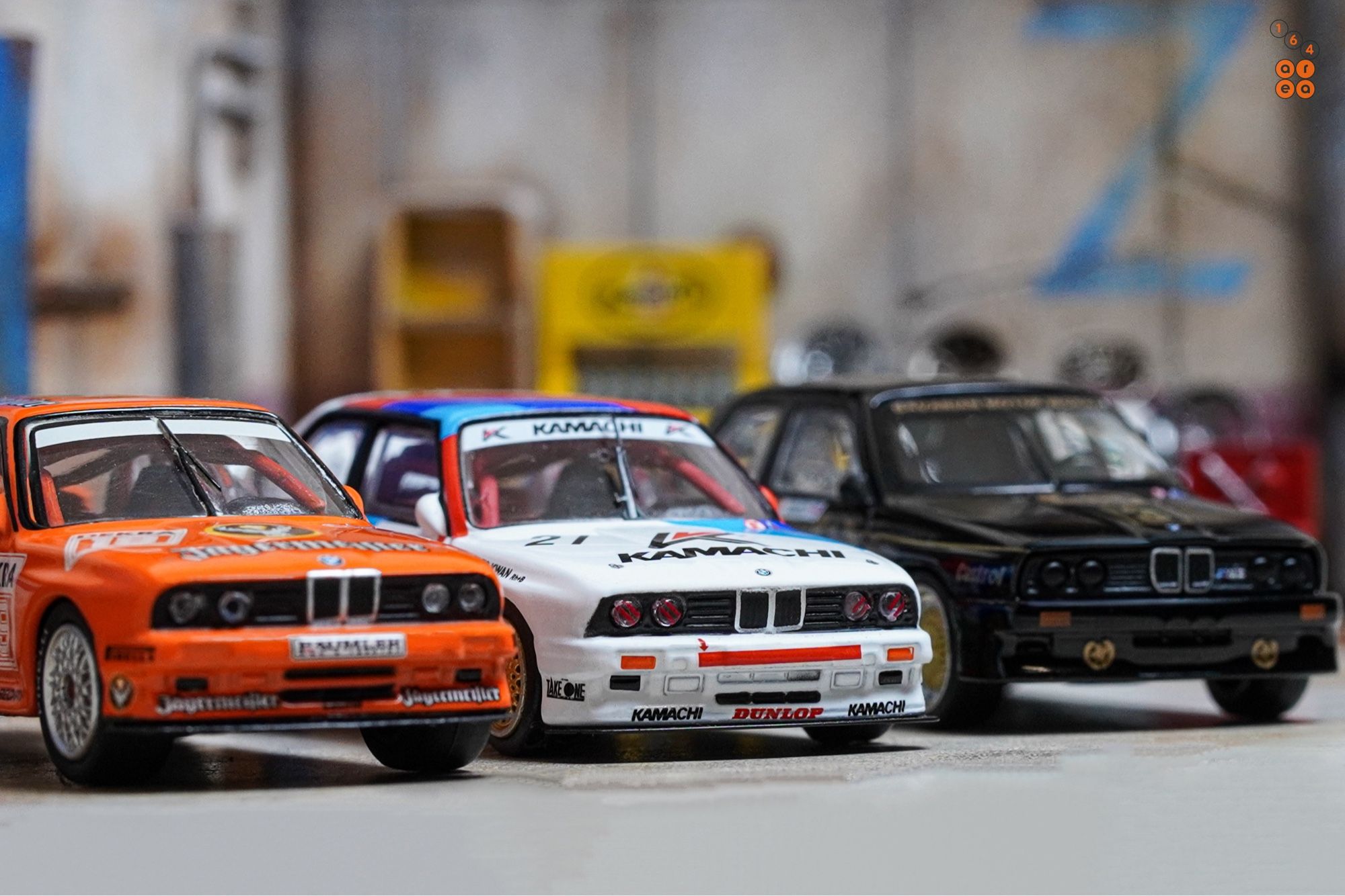 Three BMW E30 M3 cars by Tarmac Works in 1:64 scale on AREA 164