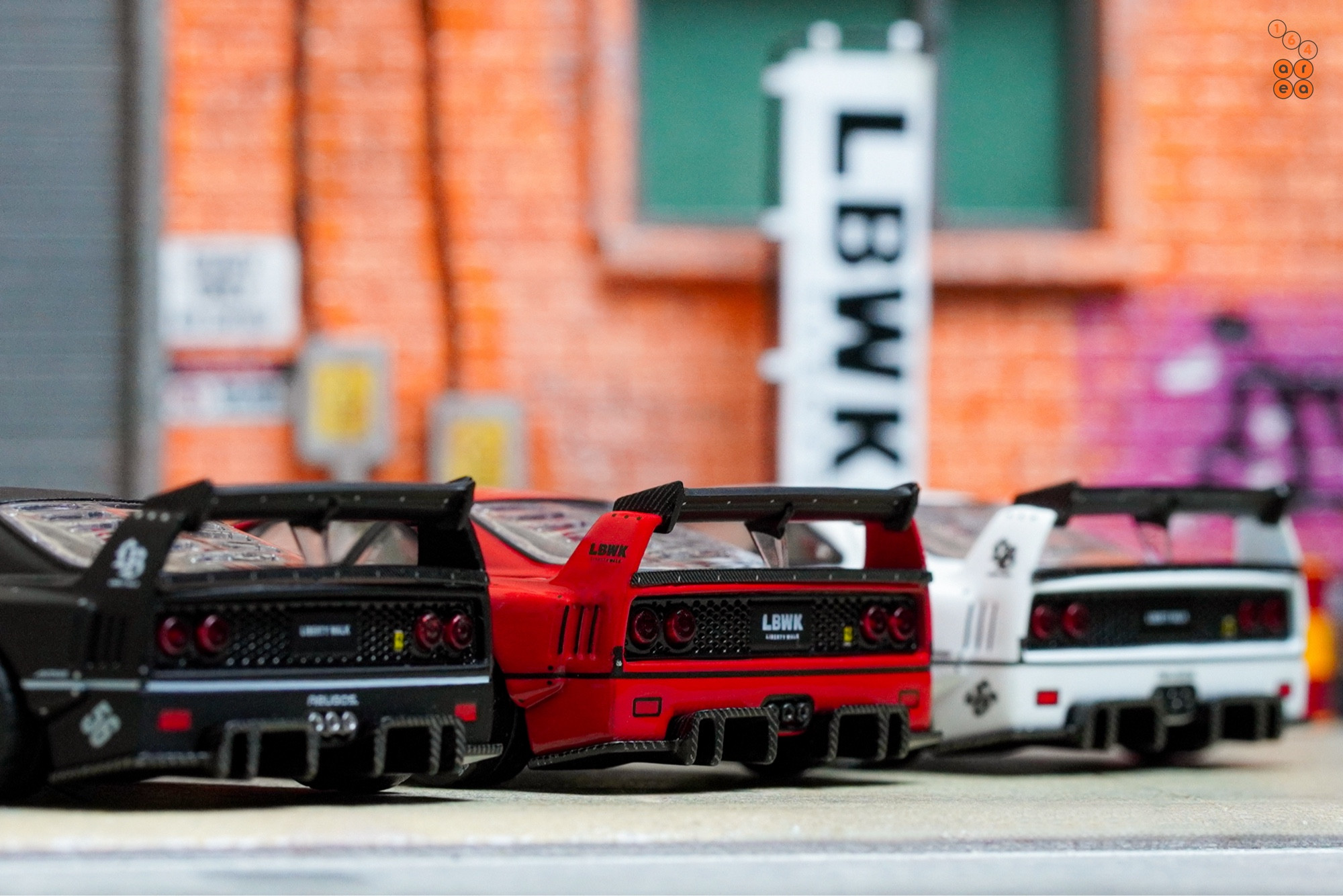 A rear side of 3 LB-WORKS Ferrari F40 cars by INNO64 in 1:64 scale on AREA 164