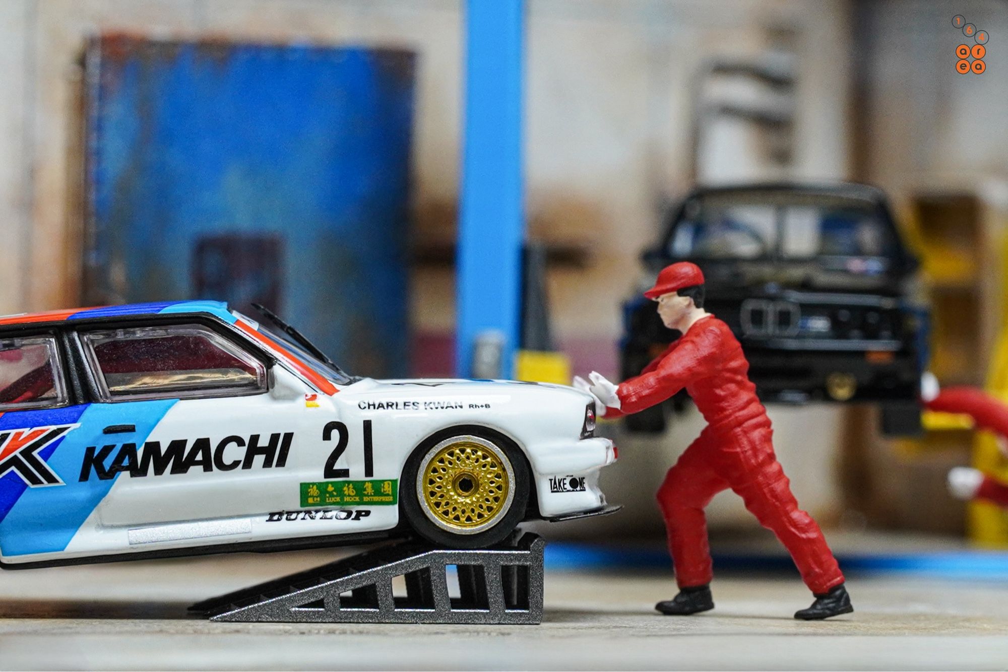 A mechanic and BMW E30 M3, Kamachi racing livery by Tarmac Works in 1:64 scale with 1:64 figure on AREA 164