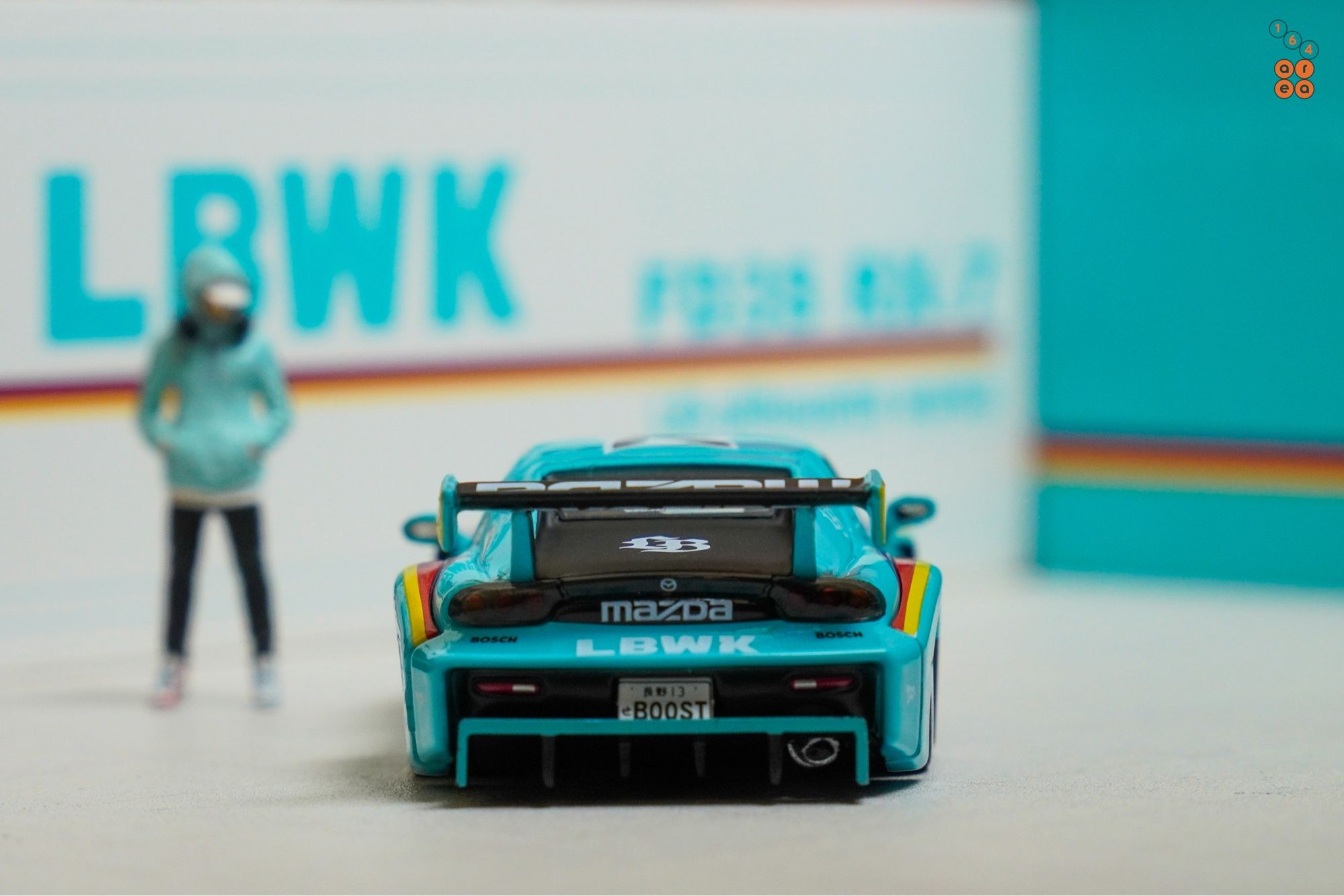 A rear side of Mazda RX-7 FD3S, LB-Super Silhouette, Hobby Expo China 2024 Edition by iNNO64 in 1:64 scale with 1:64 figure on AREA 164