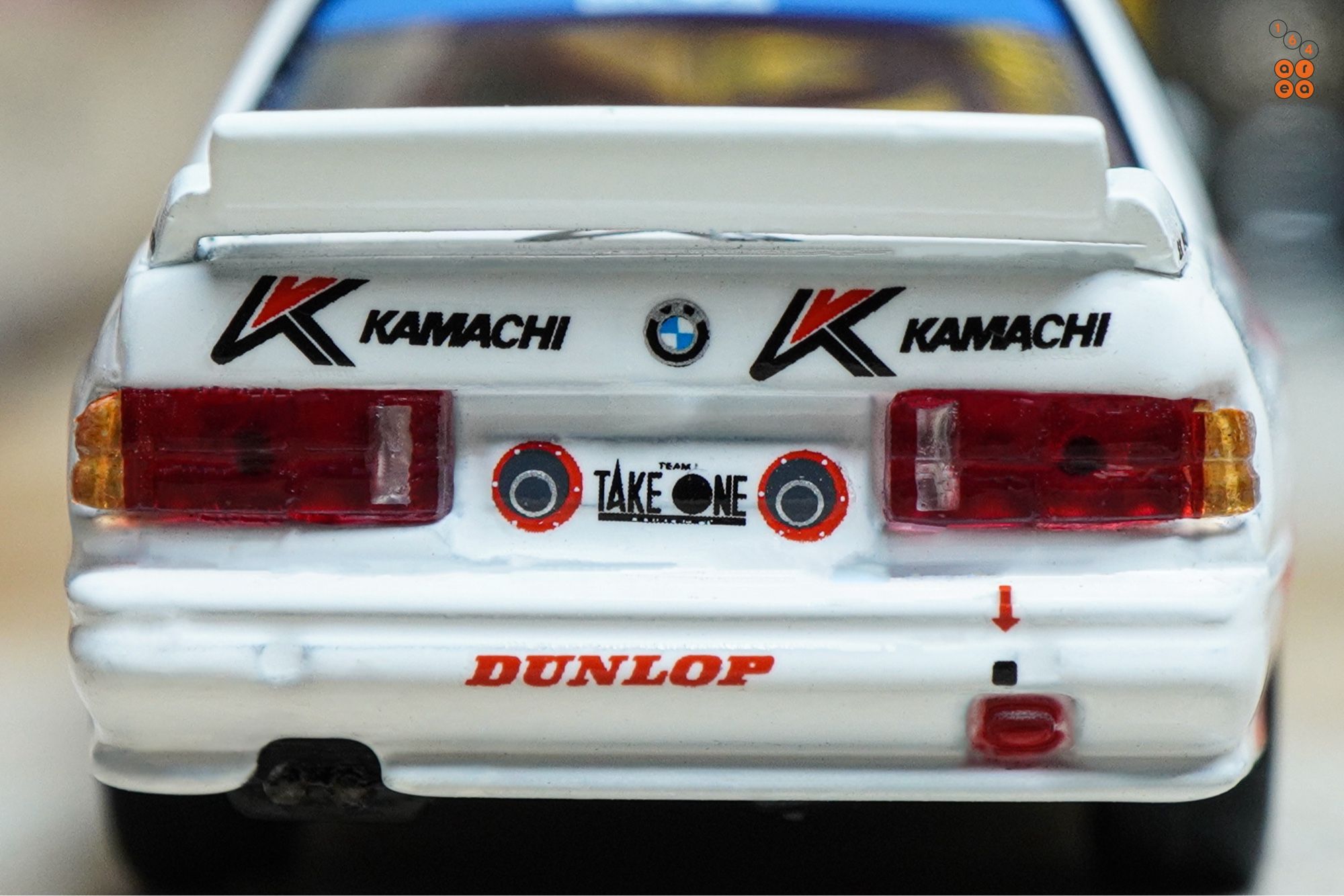 A close-up shot of BMW E30 M3, Kamachi racing livery by Tarmac Works in 1:64 scale  on AREA 164