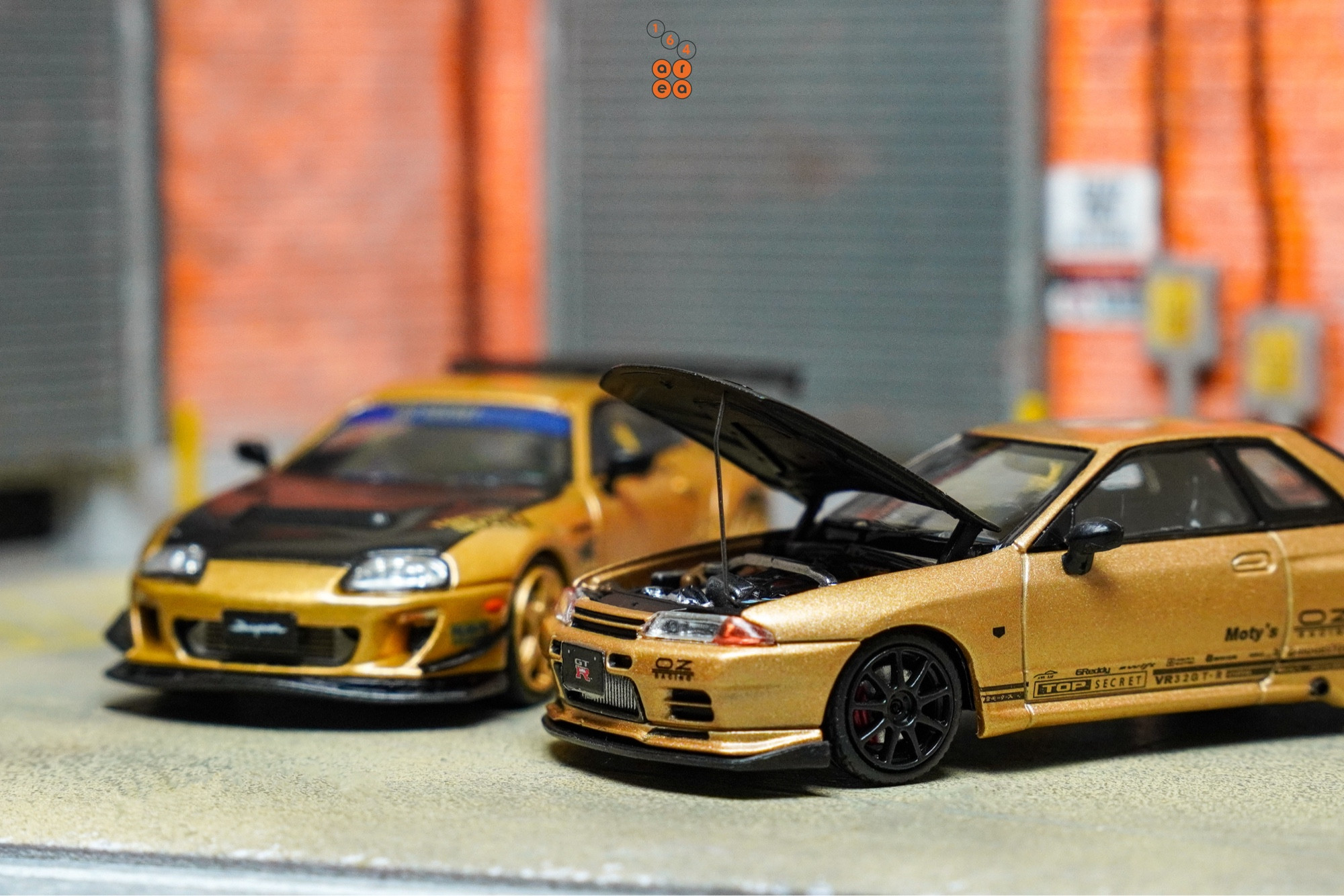 Toyota Supra A80 by Time Micro and Nissan Skyline GT-R VR32 by Facal Horizon both with Top Secret Gold livery in 1:64 scale on AREA 164