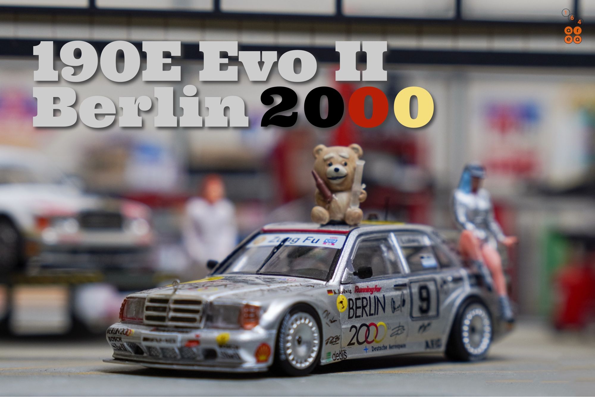 A left side of Mercedes-Benz 190E 2.5-16 Evolution II, Berlin 2000 livery by Tarmac Works in 1:64 scale with 1:64 figures on AREA 164