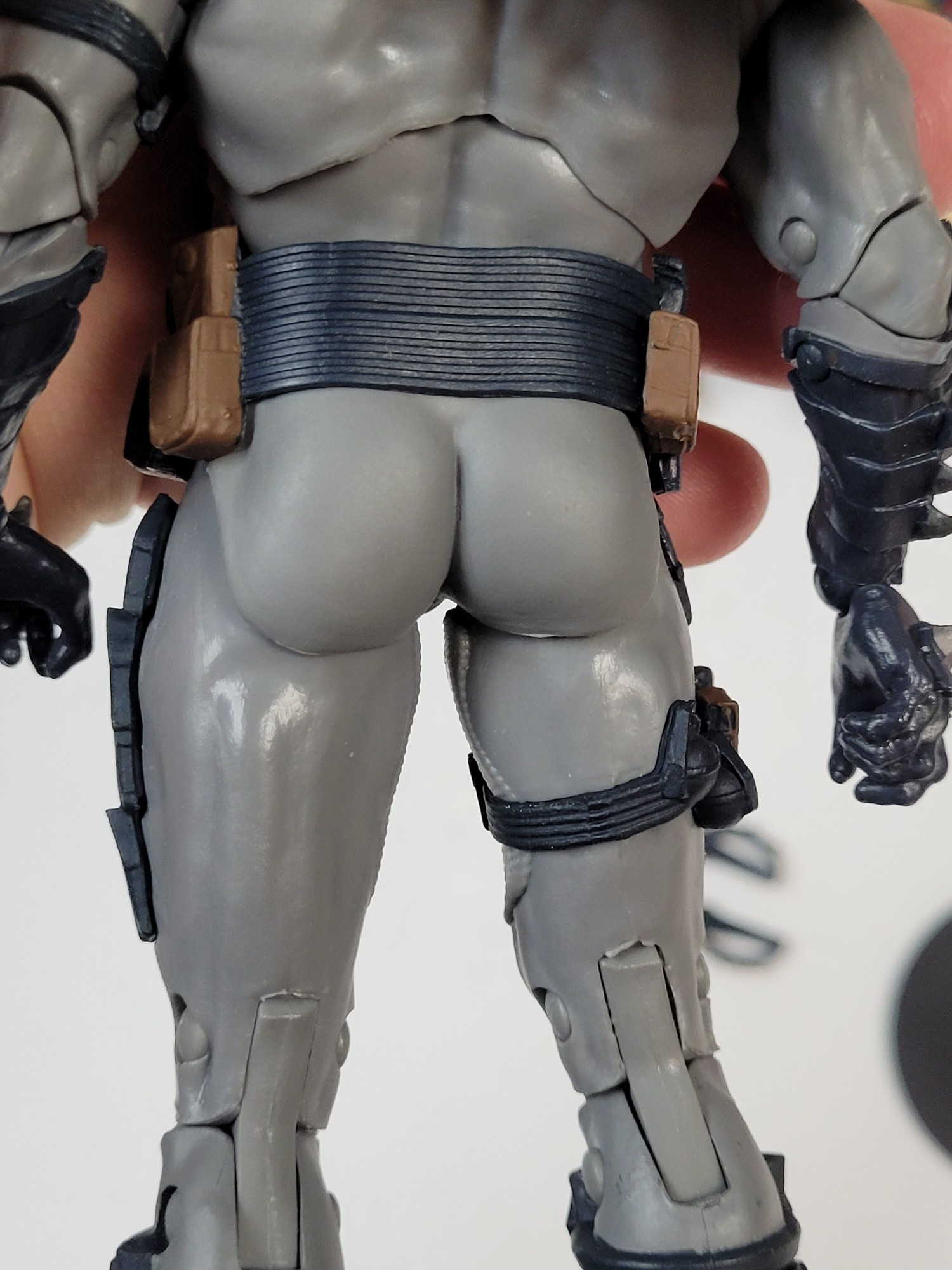 rear view of the mcfarlane designed batman figure, under his cape he has the fattest, most perfectly contoured ass you've ever seen this side of nightwing. he's caked up like a himbo king.