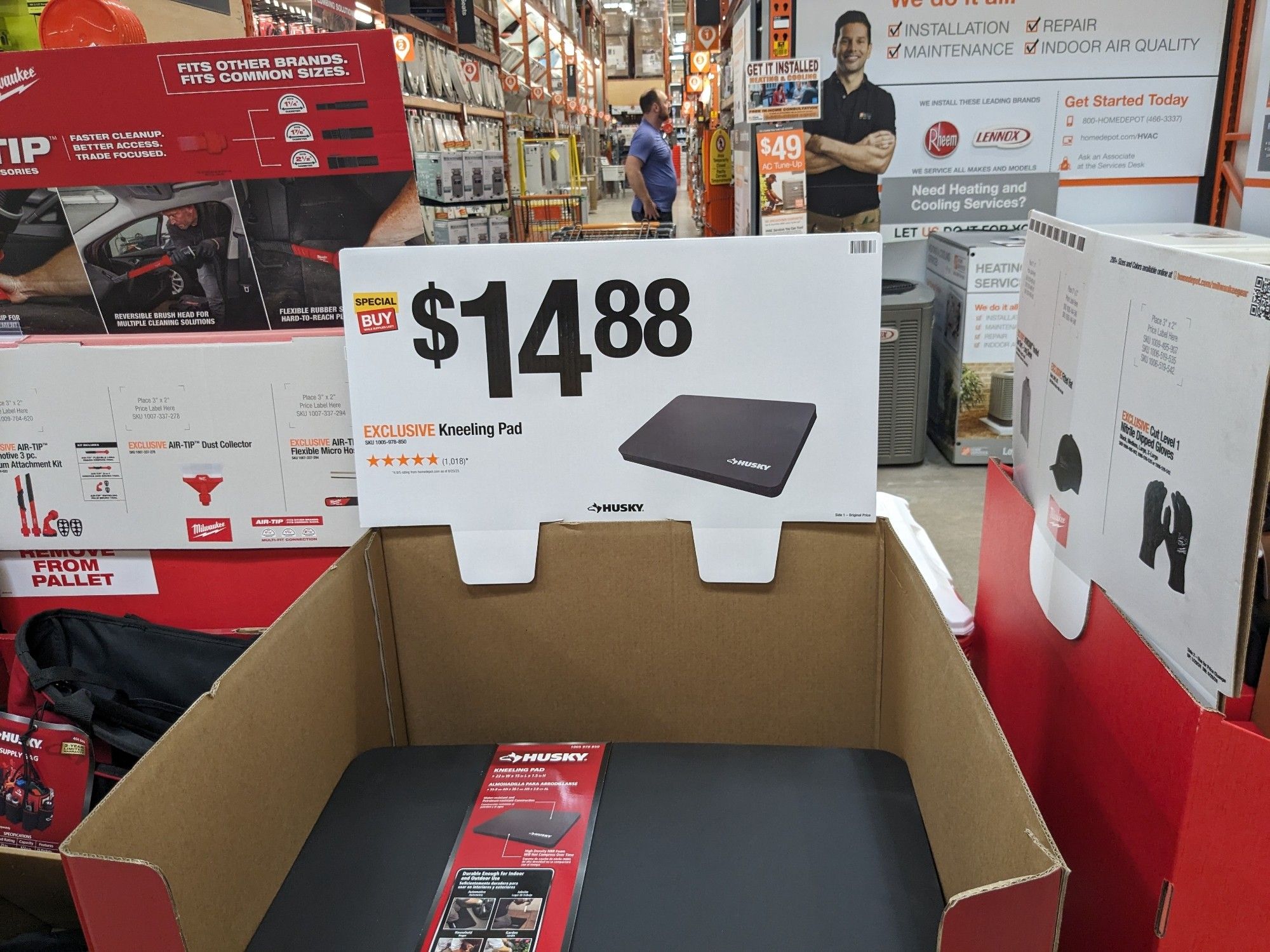 a product display at Home Depot for a foam-rubber rectangle sold as a kneeling pad. the price is marked on a sign with digits maybe 20cm tall. the price is $14.88