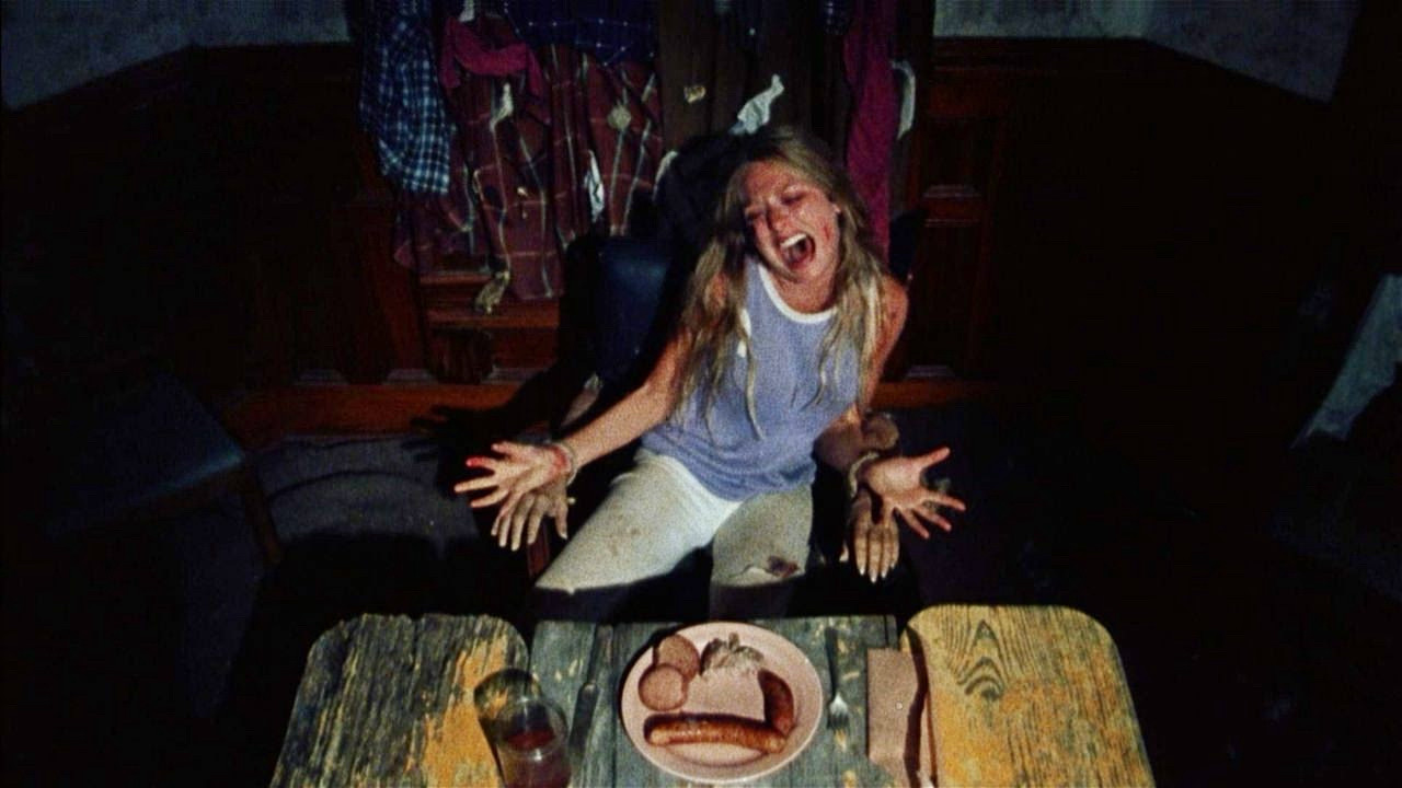 screenshot from the Texas Chain Saw Massacre of Sally at the dinner table