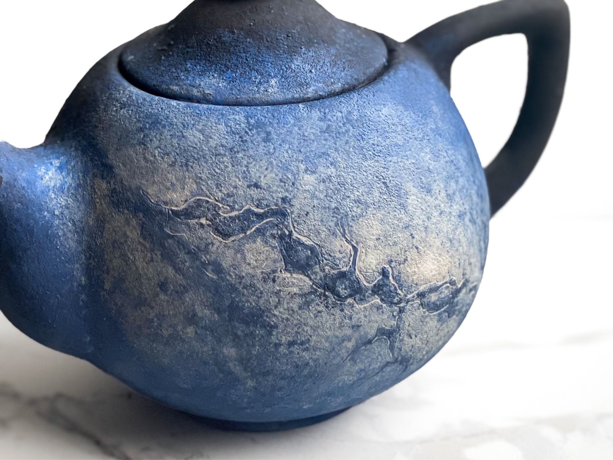 Teapot that features soft view of Milky Way galaxy. (Left detail)