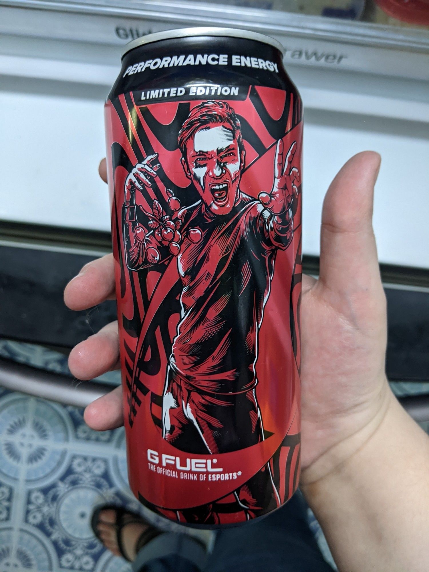 a red gfuel can with a generic white man posturing at the camera with some berries in front of him. see next alt text for the fun surprise of who it is.