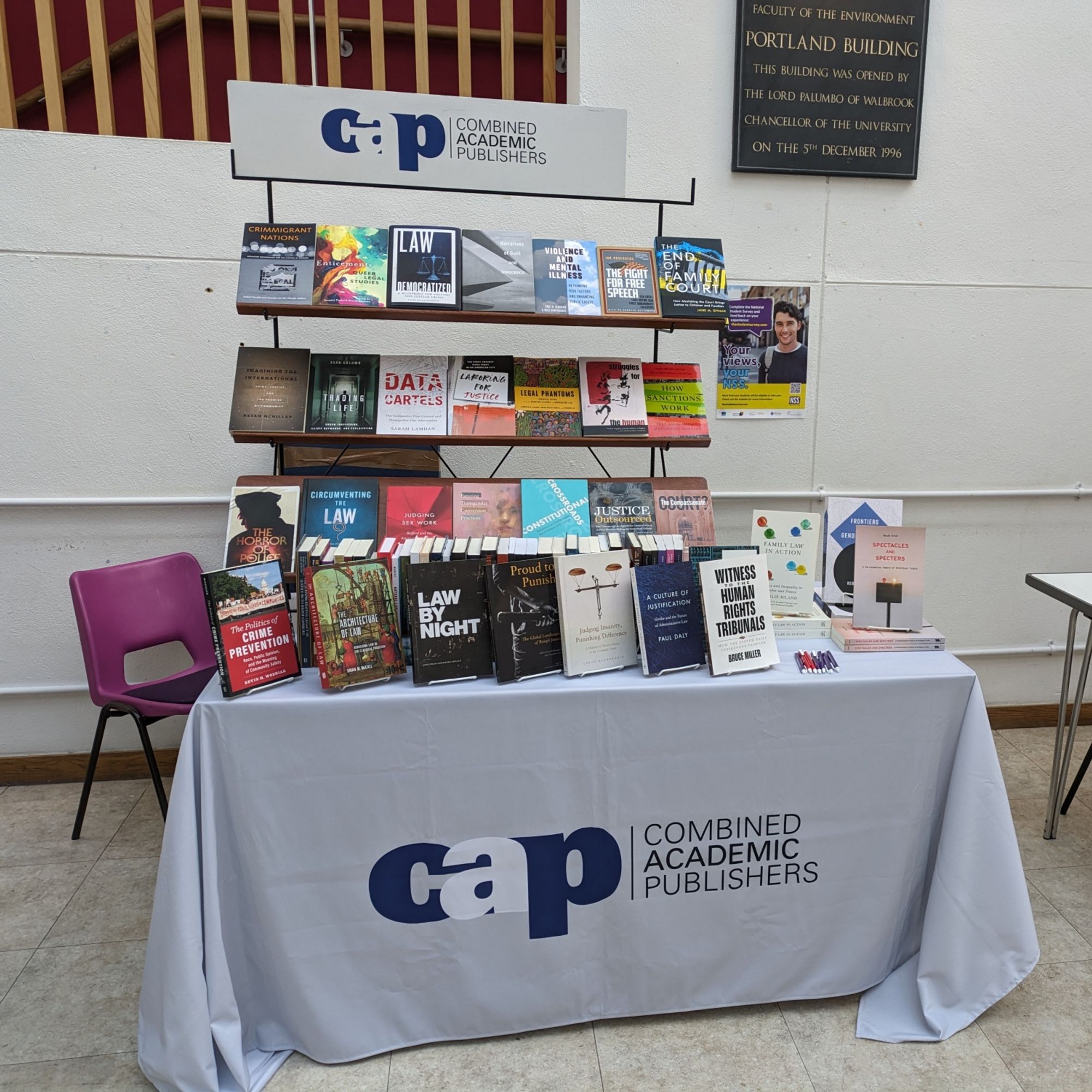 A table heavy with University Press socio-legal books ready for the SLSA conference starting 26th March 2024