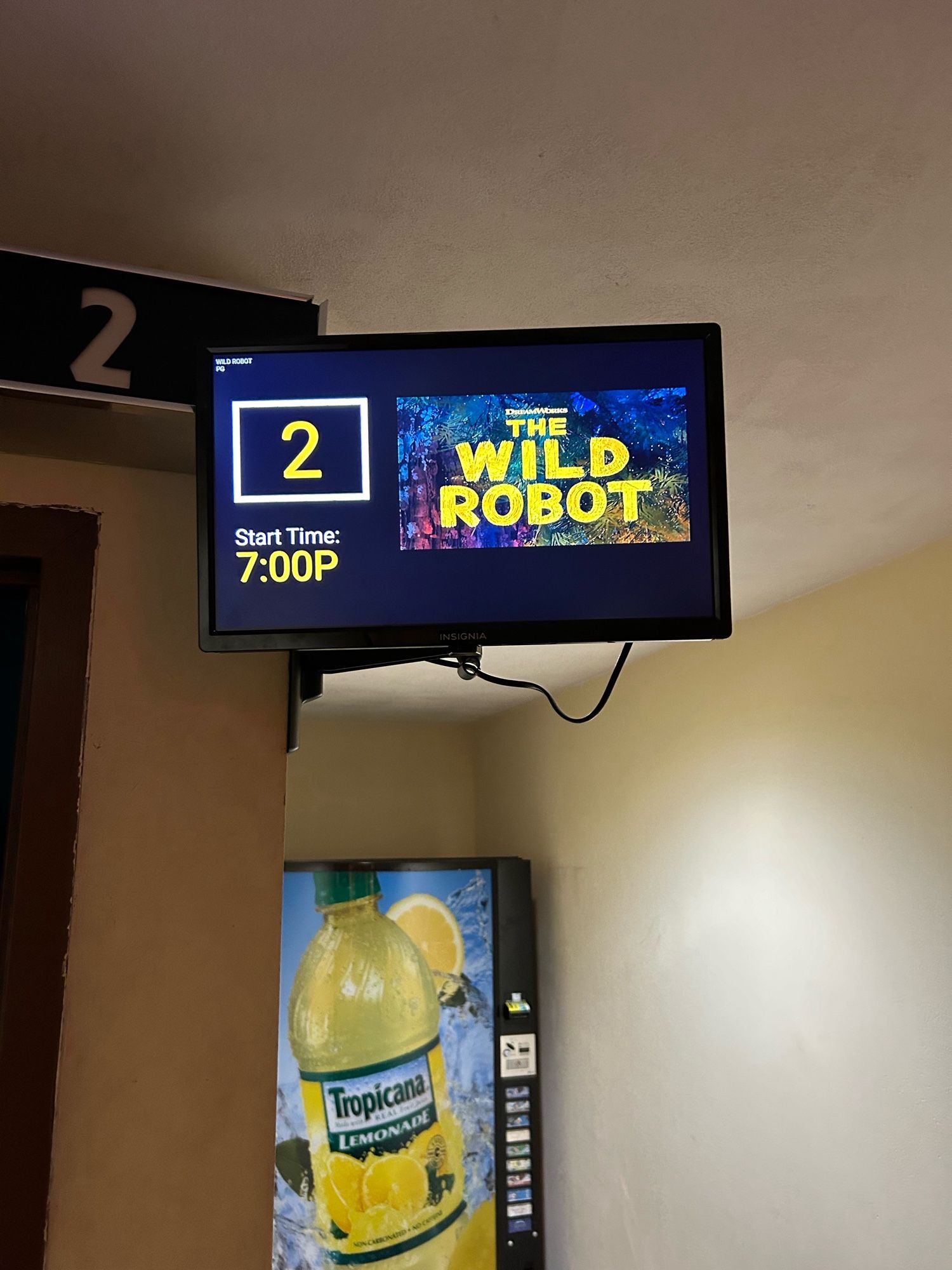 7:00 PM screening of The Wild Robot in Auditorium 2. A Tropicana vending machine is in the background.