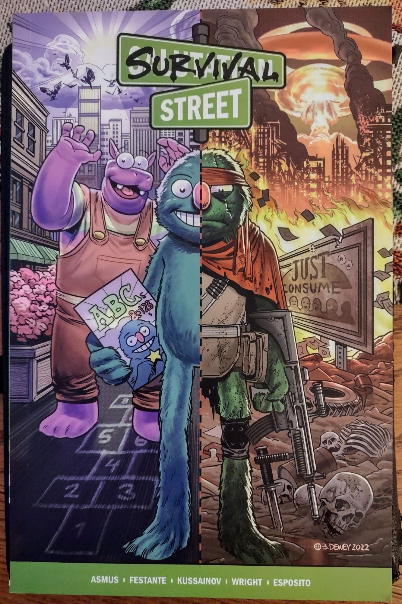 Survival Street vol. 1 paperback. Cover by Benjamin Dewey. The puppet Herbert bisected in two images: one half on the kid-friendly Salutation Street, the other as gun-toting Corporal Punishment in the violent capitalist hellscape.