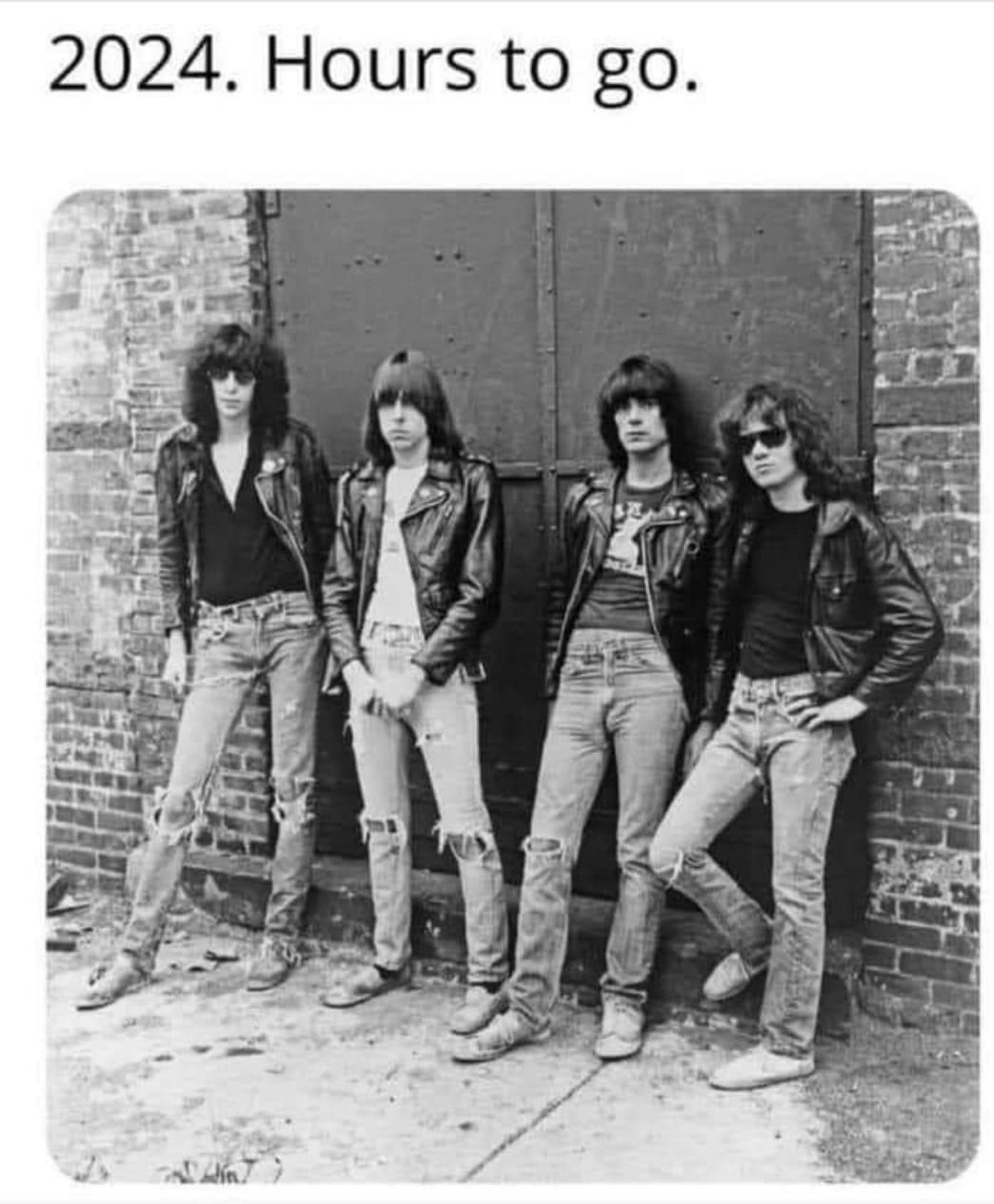 The band the Ramones standing up against a wall, looking either really cool or really dumb, depending on how you feel about them.