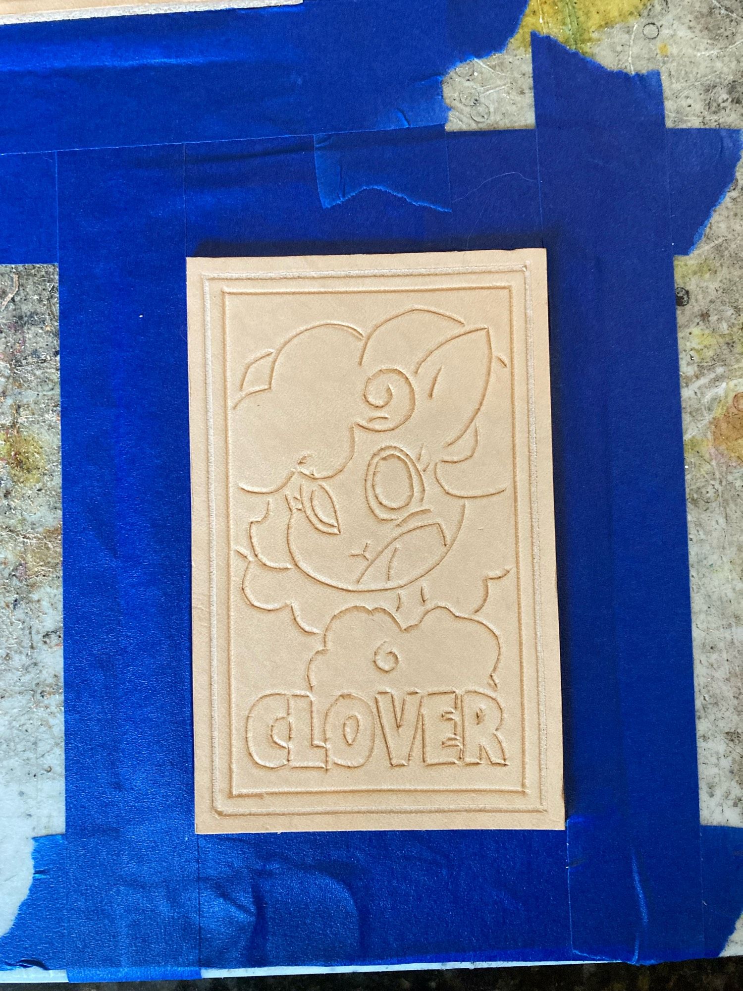 Unfinished leather patch of a sheep with text “CLOVER”