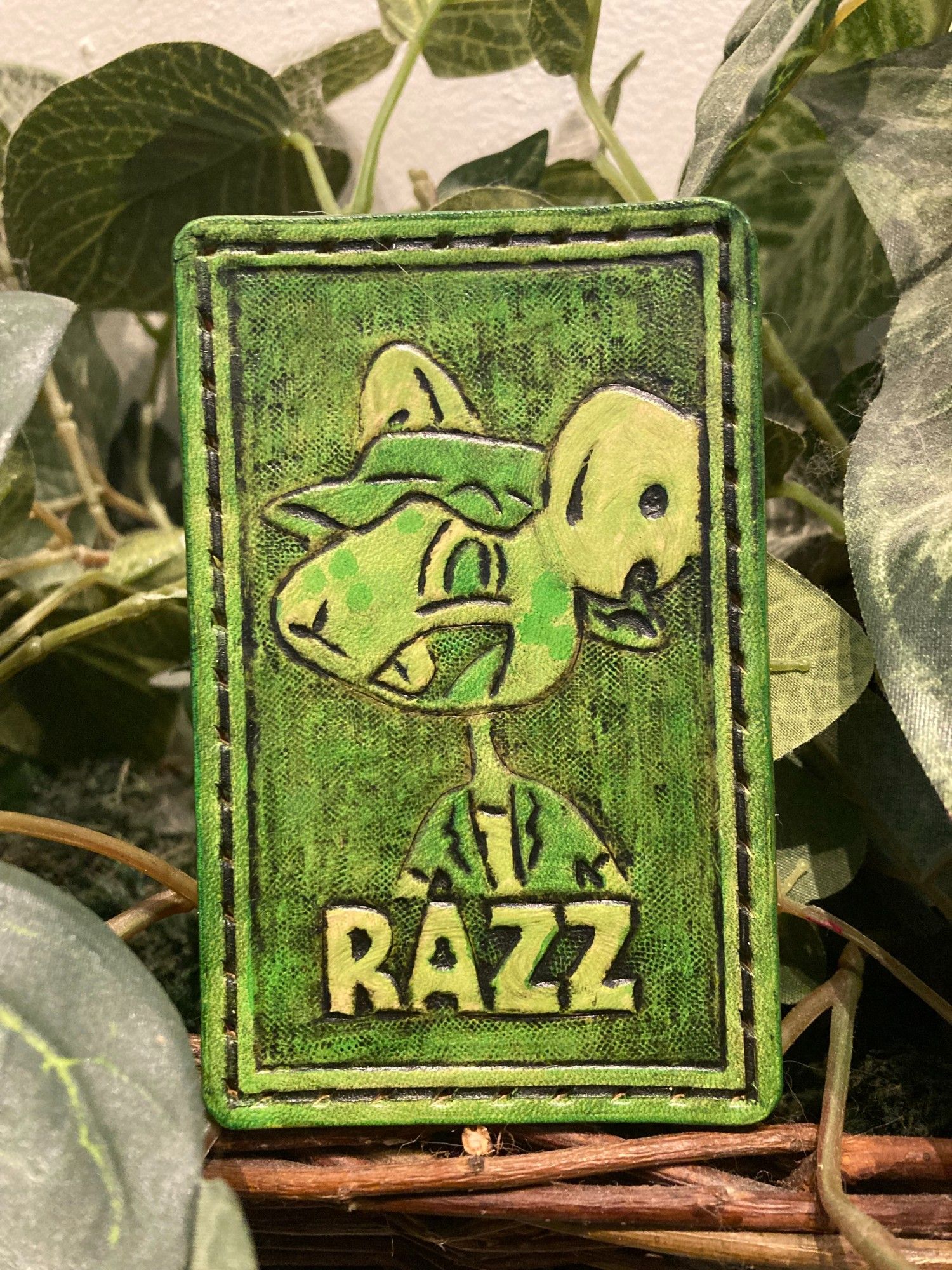 Green leather patch featuring a rat and the text "RAZZ"