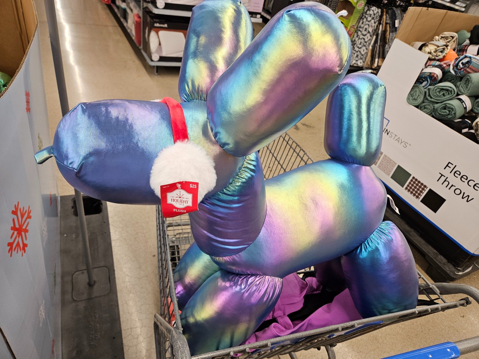 Iridescent blue purple green pink stuffed animal looks like a balloon dog. It's easily bigger than a 2 year old