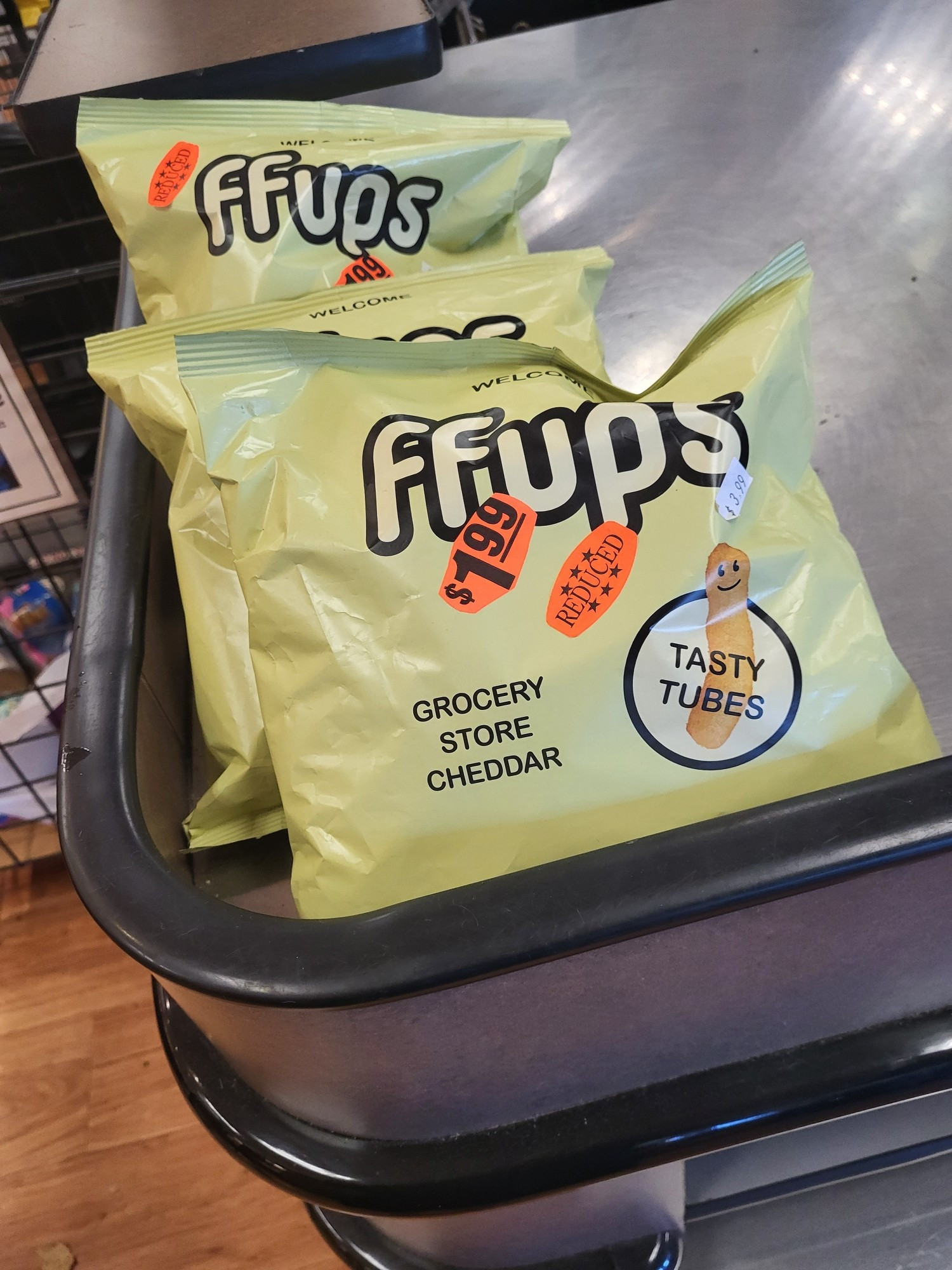 Bag of cheese snacks called "ffps." Marked down to $1.99. They appear to be similar to cheese doodles or puffy cheetos. The bag calls them "tasty tubes"