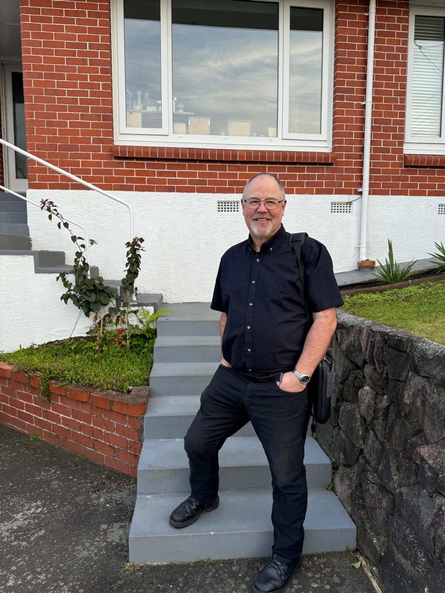 Steve standing on the steps of his home, leaving for his first day of work at a new job.