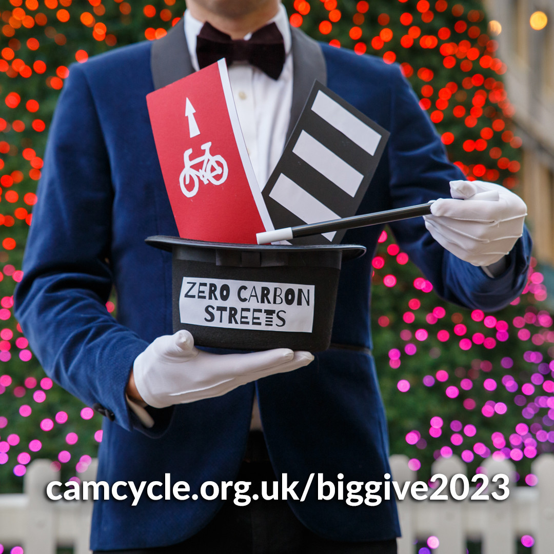 Magician conjuring a cycle lane and zebra crossing from a hat labelled 'Zero Carbon Streets'