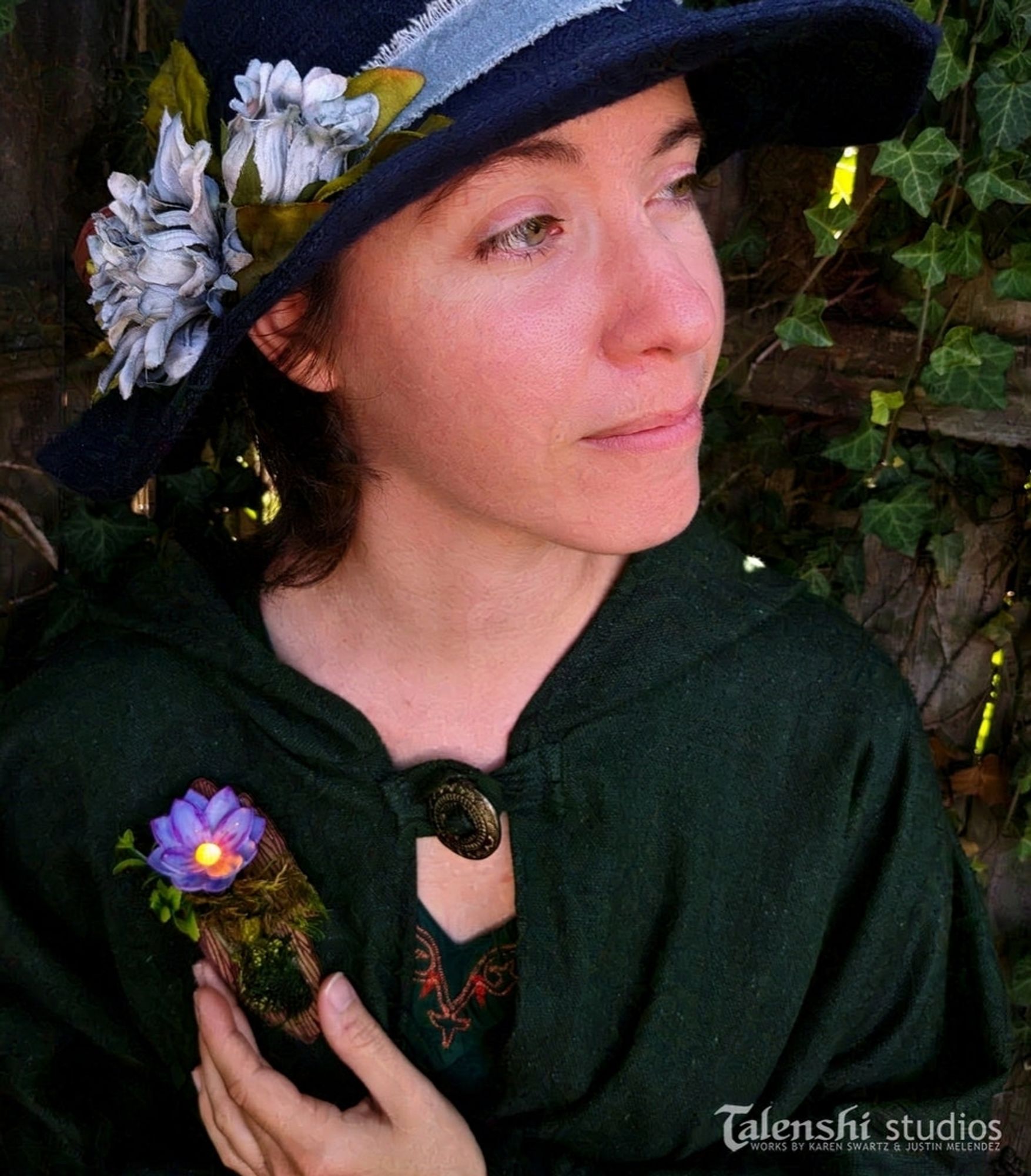 Karen wearing the lavender dream enchanted flower brooch on her cloak