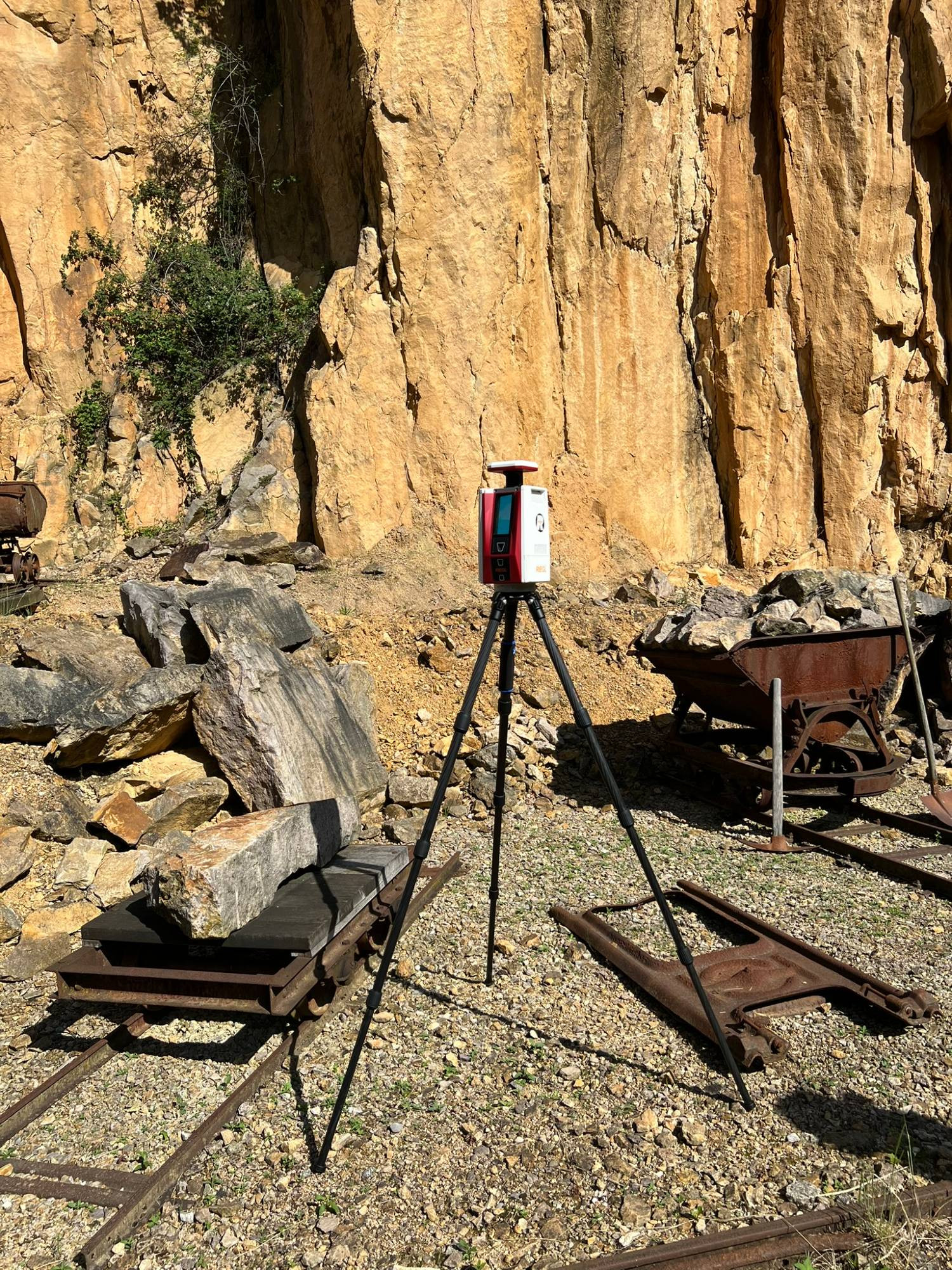 Image of a terrestrial laser scanner on a tripod at the quarry