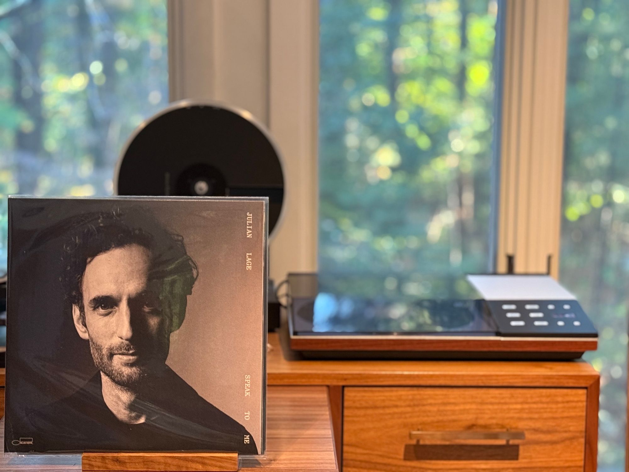 Julian Lage - Speak to Me LP cover.

A black and white portrait of Julian Lage.

The black LP plays on a vintage, restored Bang & Olufsen Beogram 8002 linear-tracking turntable to the right.