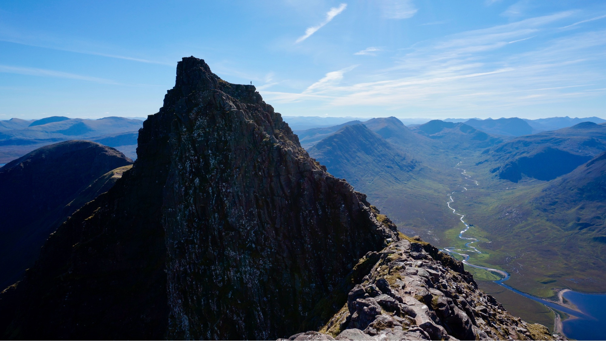 Rocky pinnacle called Lord Berkeley’s Seat on the An Teallach ridge (An Teallach means The Forge) - with Fisherfield behind