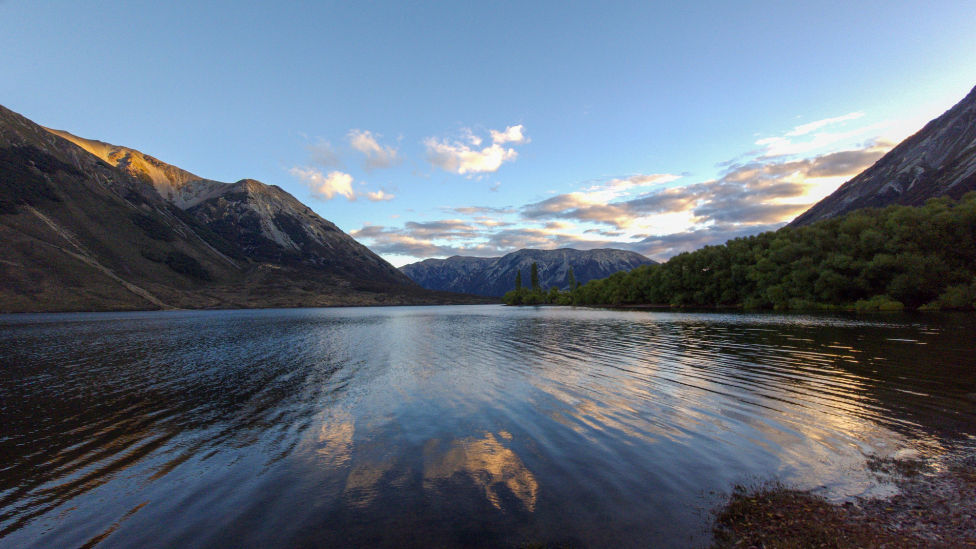 Early evening skies over Moana Rua/Lake Pearson, reflected in the rippled water of the lake.