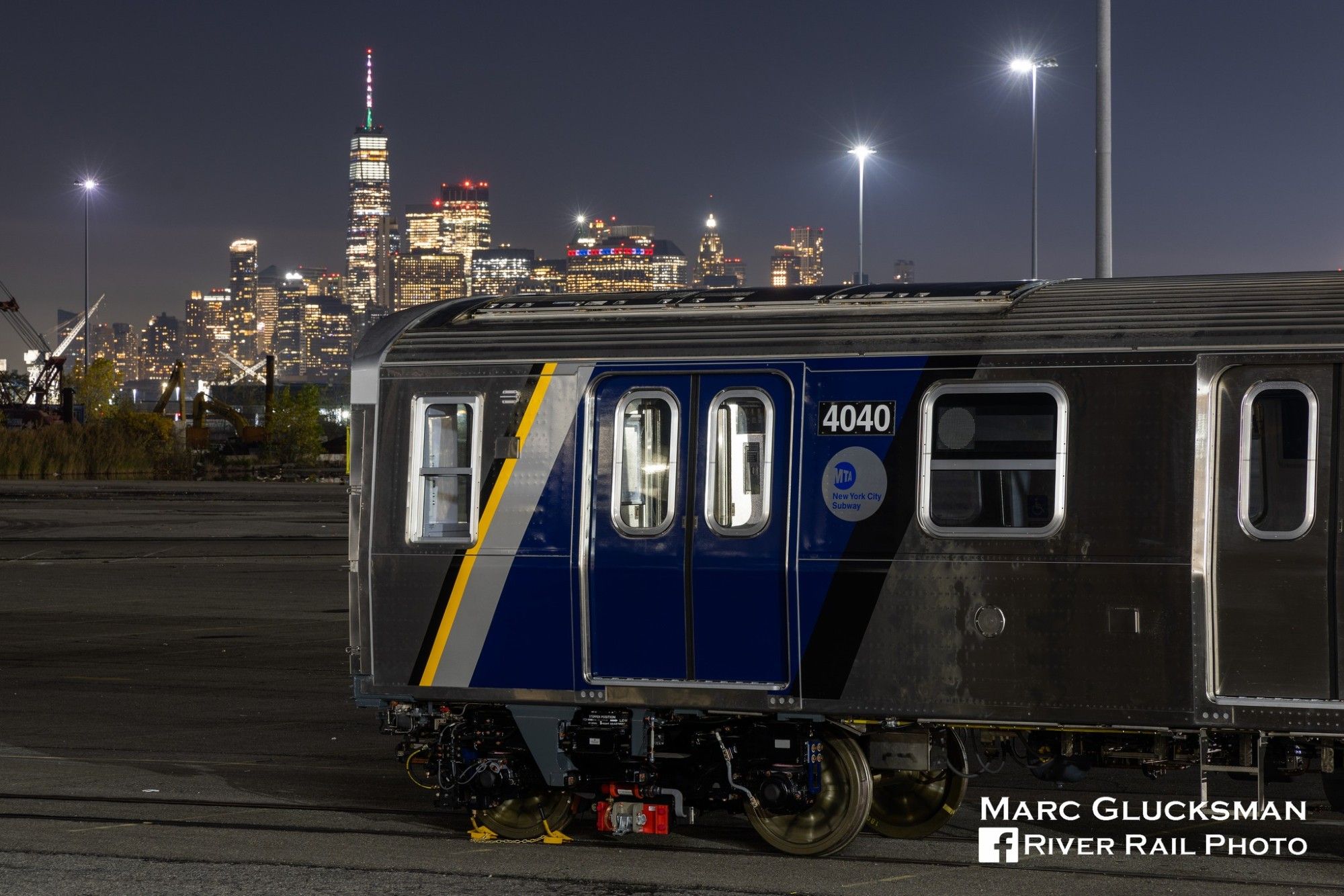 NYC Subway Car Type "R211T" in the night sky with the Freedom Tower in the backround.