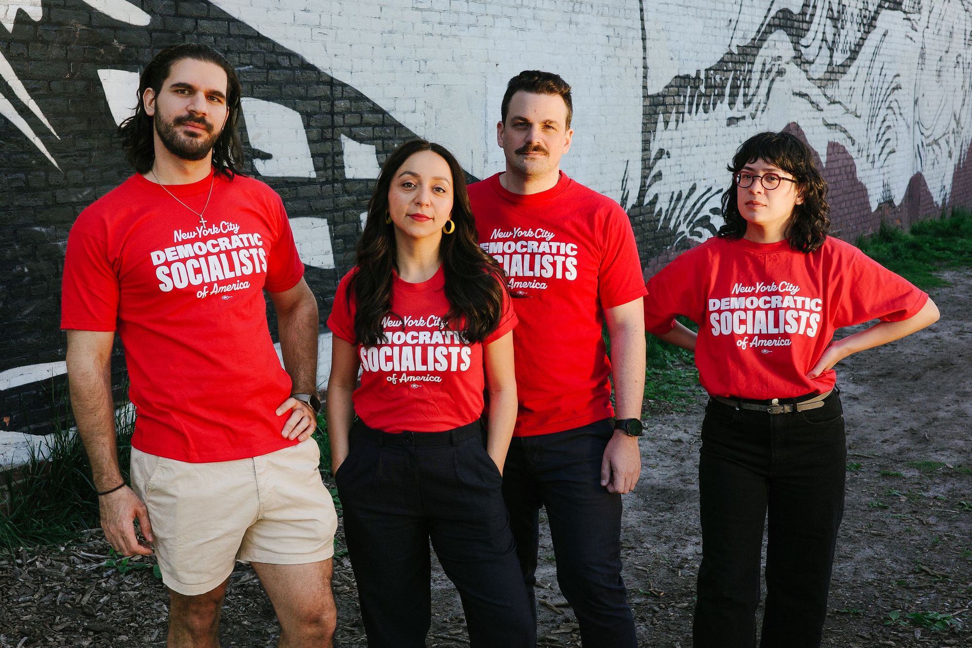 Group of 4 people outside wearing red shirts reading "New York City Democratic Socialists of America"