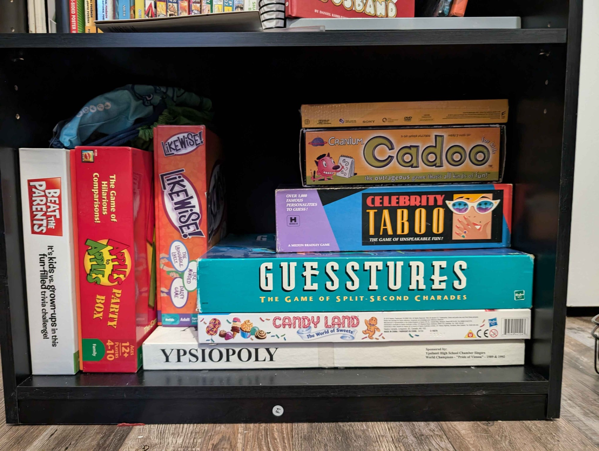 my board game collection: beat the parents, apples to apples, likewise, guesstures, celebrity taboo, cadoo, and ypsiopoly