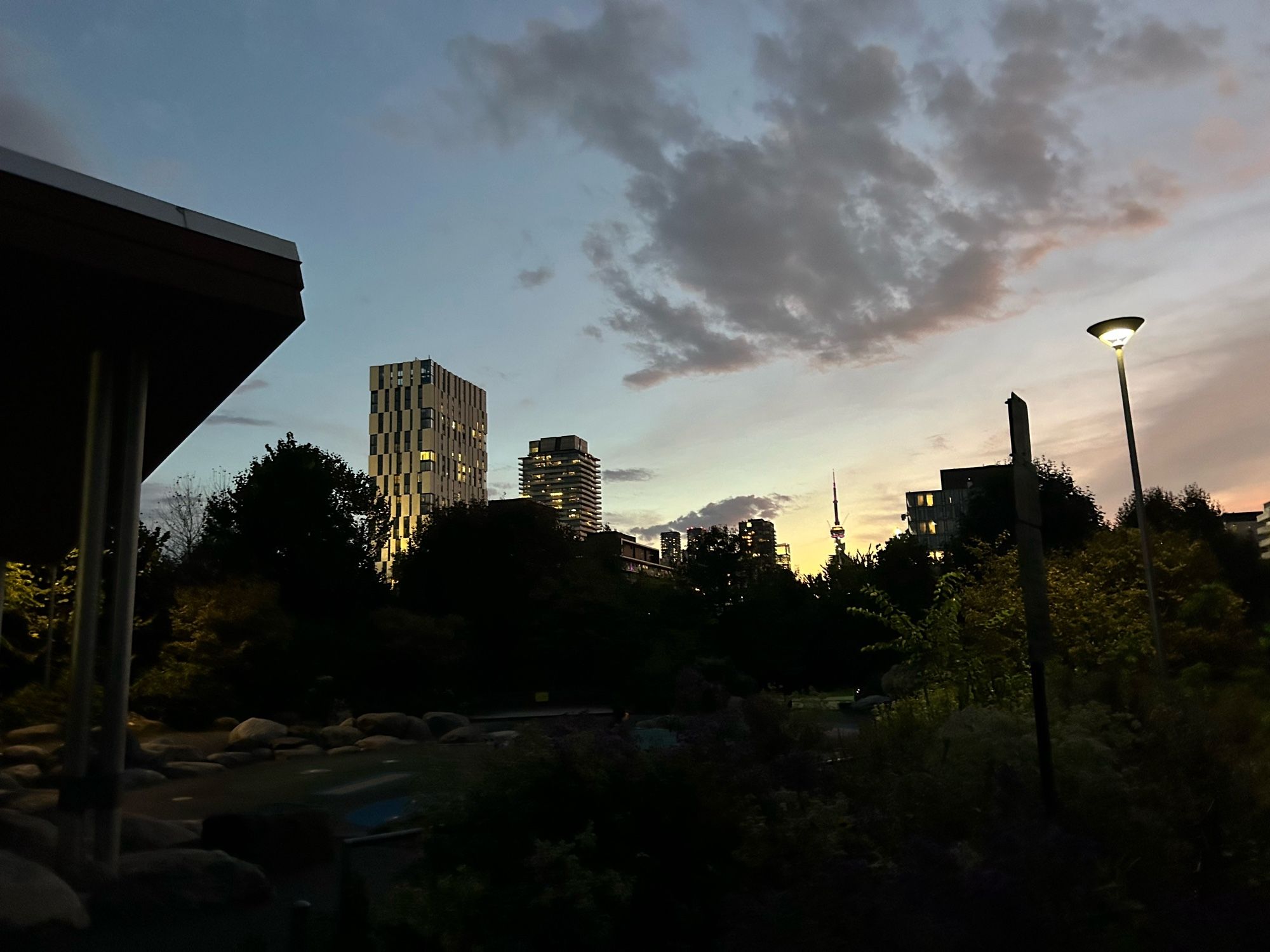 Sunset at Corktown Common looking west towards the downtown core/CN Tower, clouds lit by the remaining sun