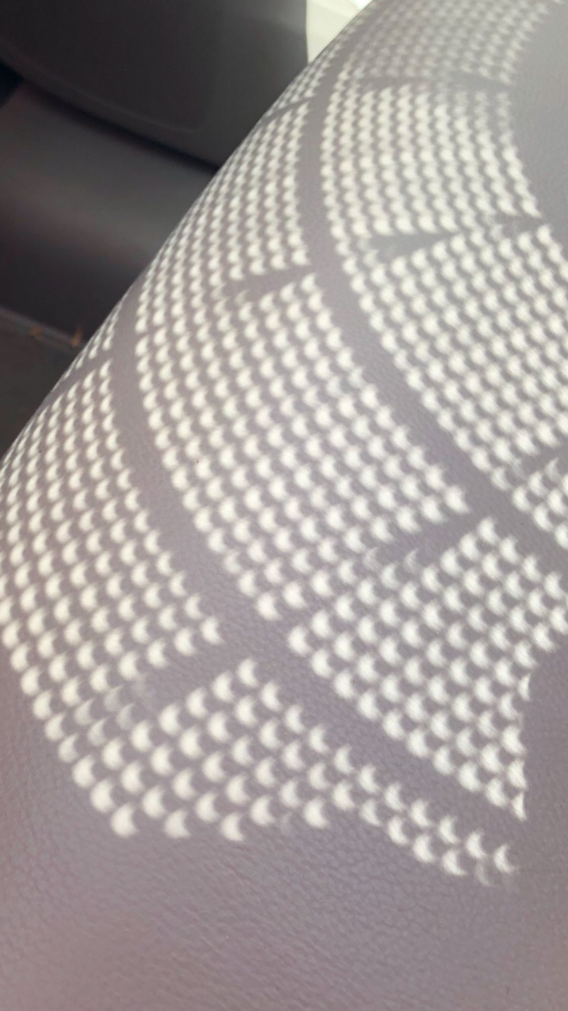 Solar eclipse seen through a colander