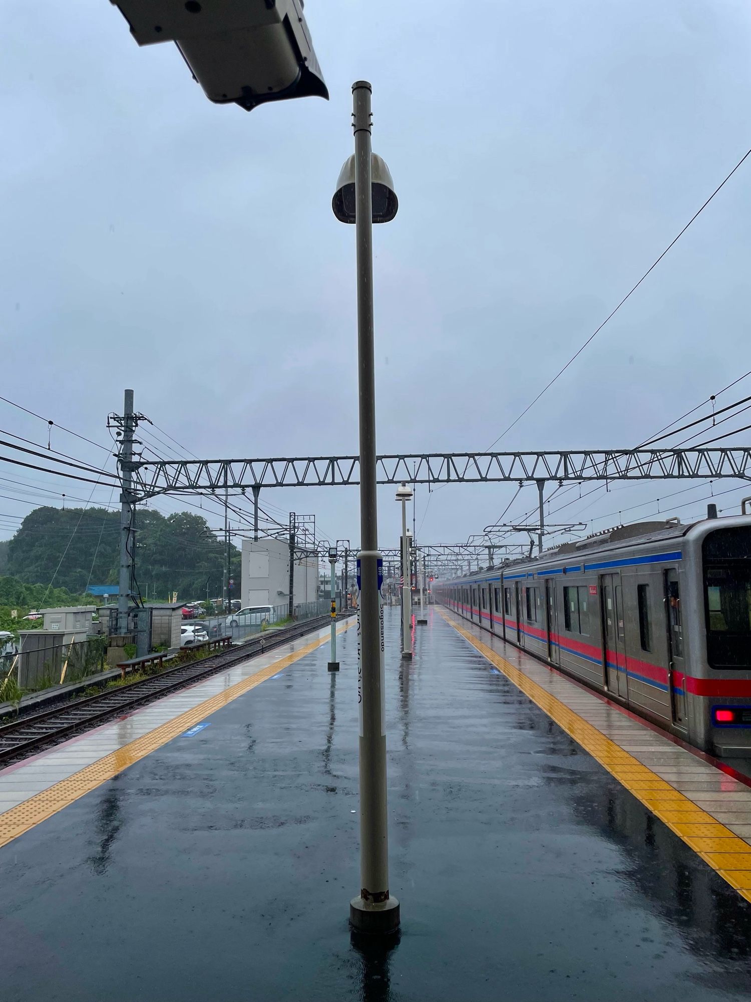 Train passes a damp, damp platform