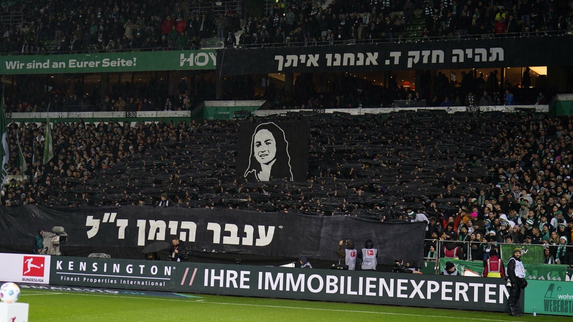 Werder Bremen's Ostkurve with a choreo in memory of Inbar Haiman, a Maccabi Haifa fan who was murdered in Hamas captivity in Gaza, featuring her name in Hebrew.