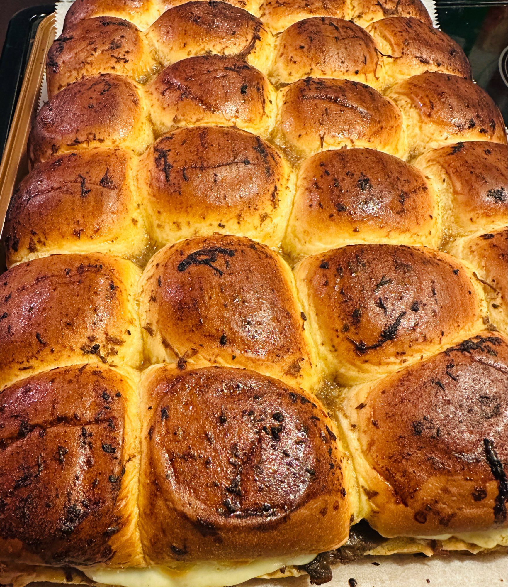 A photo of some Mississippi roast sliders that I made.  I baked them with provolone and brushed the tops of the bread with the remainder just for color.