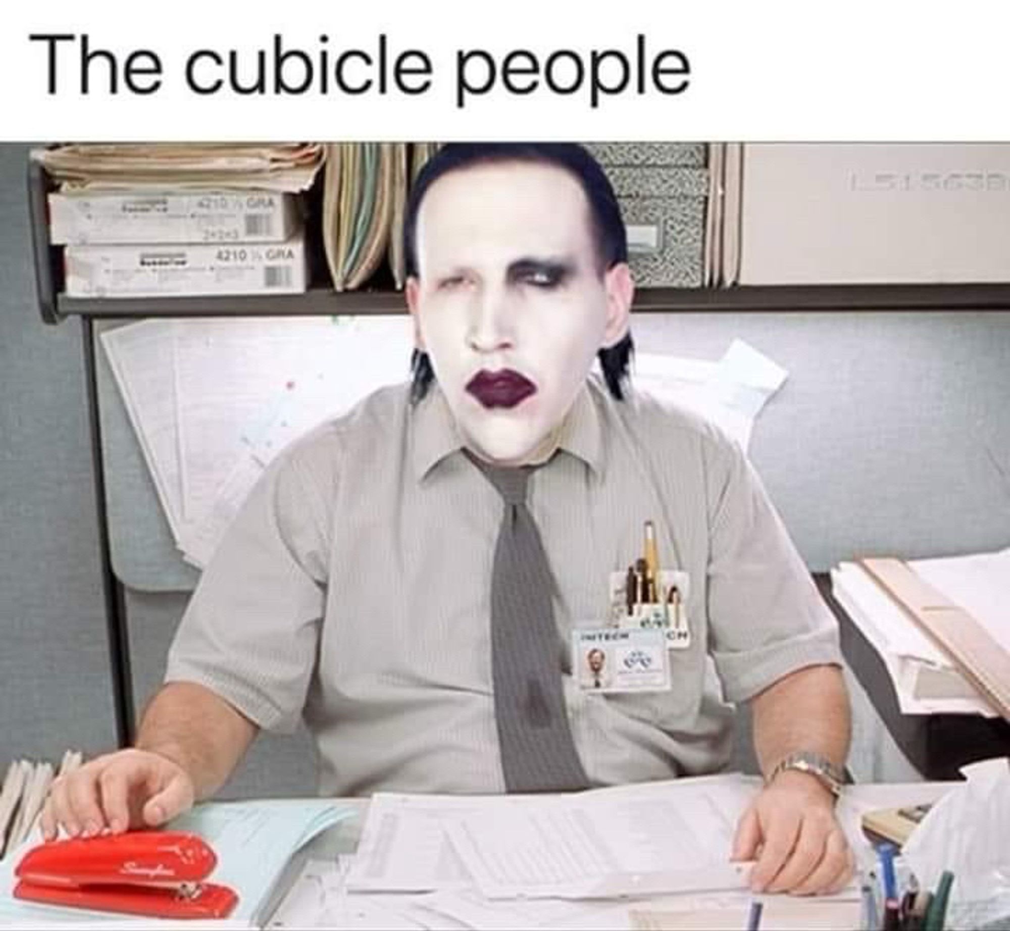 A meme of Milton from Office Space sitting in a cubicle, but his face has been swapped out with the face of Marilyn Manson.