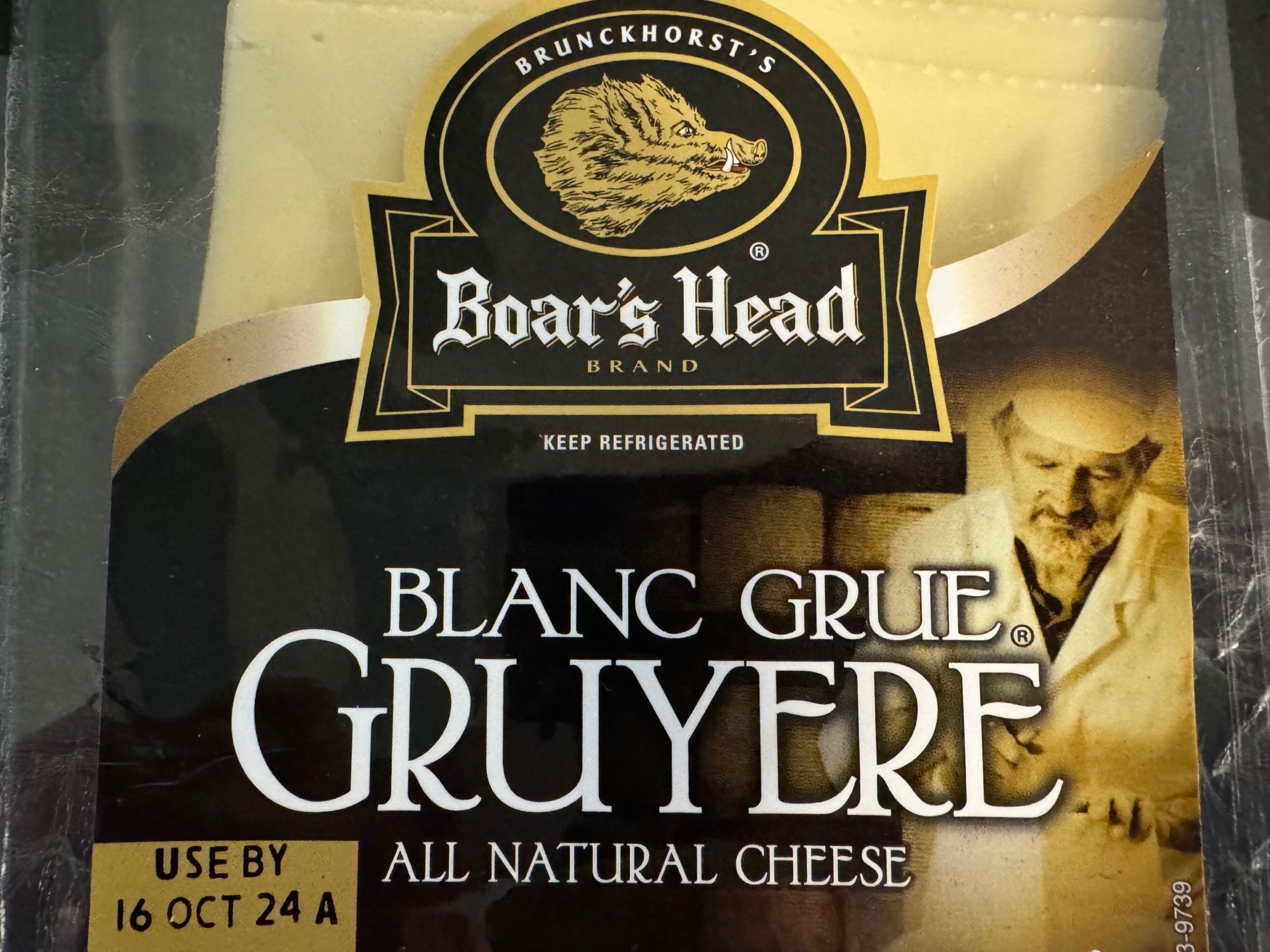 Picture of a case of Boar’s Head Blanc ***Grue*** Gruyere cheese.