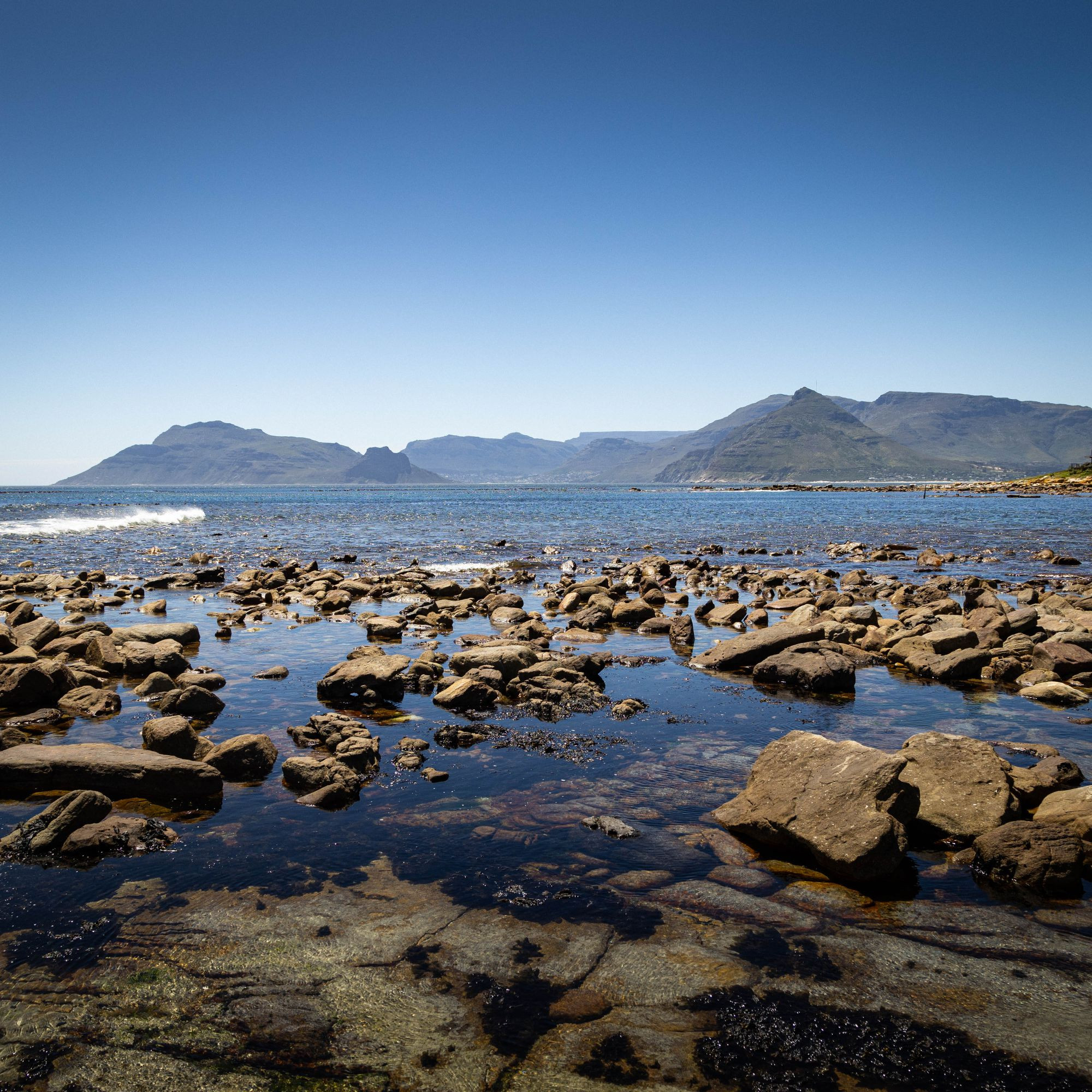 Looking at Hout Bay from Kommetjie. Karbonkelberg, and the Sentinel to the left of the bay. Chapmans Peak to the right.