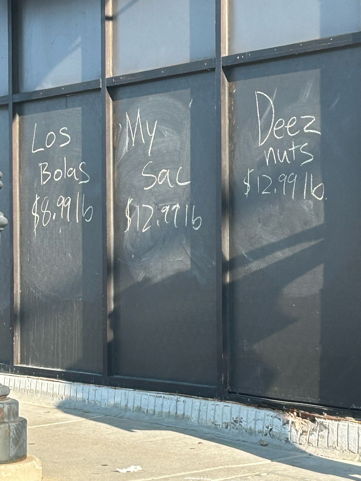 Exterior chalkboard panels .  Prices are Los Bolas, $8.99/lb, My Sac, $12.99/lb, and Deez Nutz, $12.99/lb.