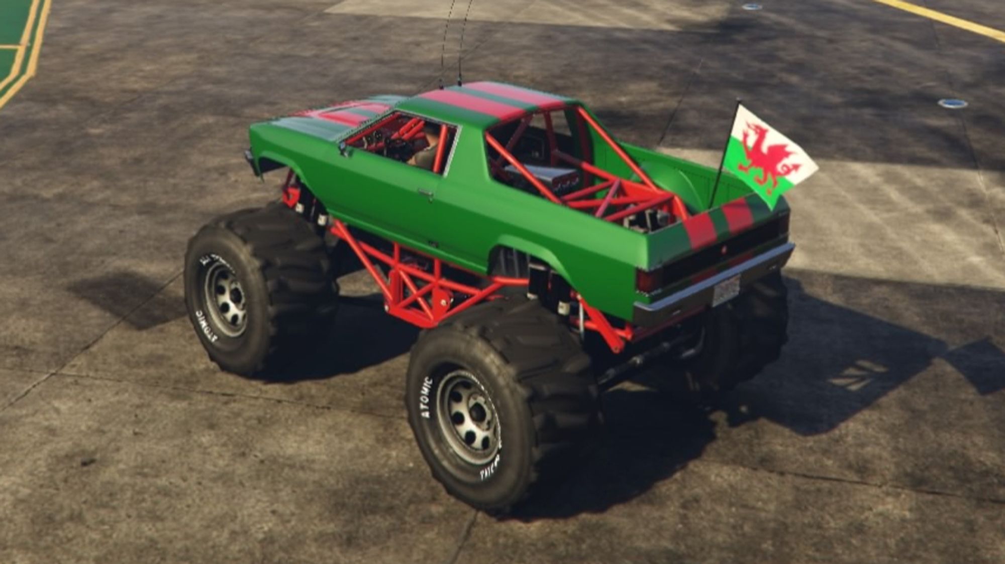 Image of the Cheval Marshall monster truck in Grand Theft Auto 5. It is modified to feature Welsh colours, mostly green and red, and has a Wales flag attached to the rear.